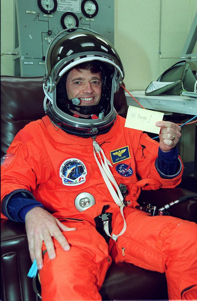 STS-100 Pilot Jeffrey S. Ashby gives a silent greeting to his wife, Paige, during suitup for launch in the Operations and Checkout Building. The 11-day mission to the International Space Station will deliver and integrate the Spacelab Logistics Pallet/Launch Deployment Assembly, which includes the Space Station Remote Manipulator system and the UHF Antenna. The mission includes two planned spacewalks for installation of the SSRMS, which will be performed by Mission Specialists Scott E. Parazynski and Chris A. Hadfield. The mission is also the inaugural flight of Multi-Purpose Logistics Module Raffaello, carrying resupply stowage racks and resupply/return stowage platforms. Liftoff on mission STS-100 is scheduled at 2:41 p.m. EDT April 19