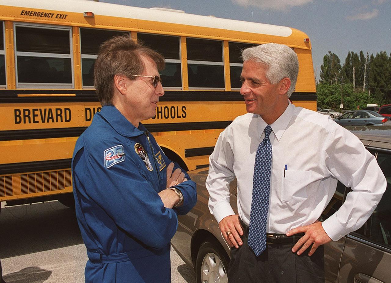 KENNEDY SPACE CENTER, FLA. -- At a launch observation site, State Education Commissioner Charlie Crist (left) talks with astronaut Sam Durrance. Crist was commemorating the 20th anniversary of Space Shuttle program with his visit to KSC for the launch of Space Shuttle Endeavour on mission STS-100. He accompanied students from Ronald McNair Magnet School, Cocoa, Fla