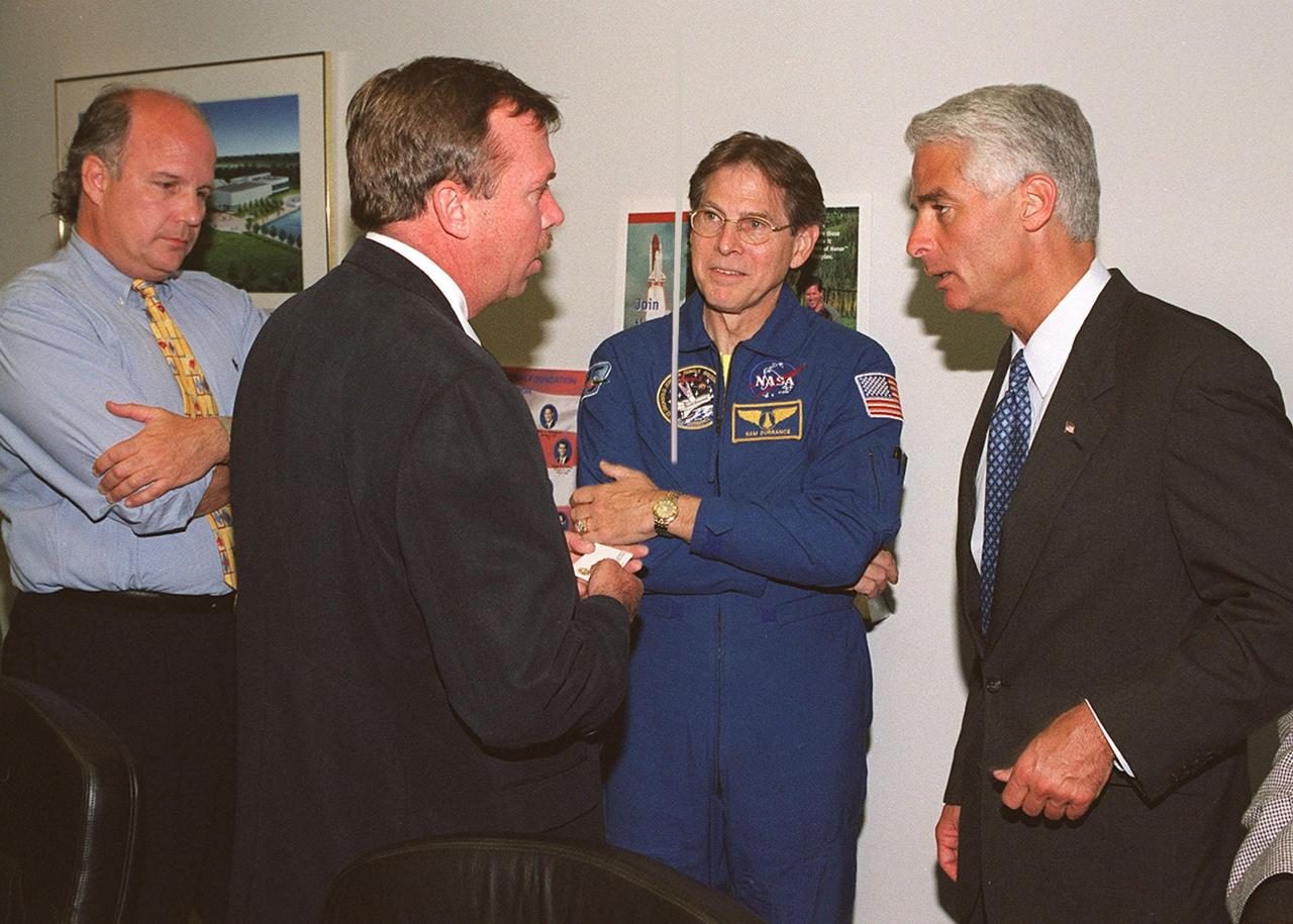KENNEDY SPACE CENTER, FLA. -- During his visit to KSC for the launch of Space Shuttle Endeavour on mission STS-100, State Education Commissioner Charlie Crist (right) talks to Jerry Moyer of Dynamac (Bionetics). At far left is Jay Burmer, FDOE, Director, Central Florida Office. Second from right is astronaut Sam Durrance. Crist and Durrance accompanied students from Ronald McNair Magnet School, Cocoa, Fla., for the launch. Crist was commemorating the 20th anniversary of Space Shuttle program with his visit to KSC