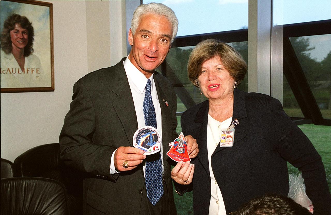 KENNEDY SPACE CENTER, FLA. -- State Education Commissioner Charlie Crist (left) accepts patches of mission STS-100 and the 20th anniversary of the Shuttle program from JoAnn H. Morgan, director of External Relations and Business Development at KSC.  Crist was at KSC to watch the launch and commemorate the 20th anniversary.