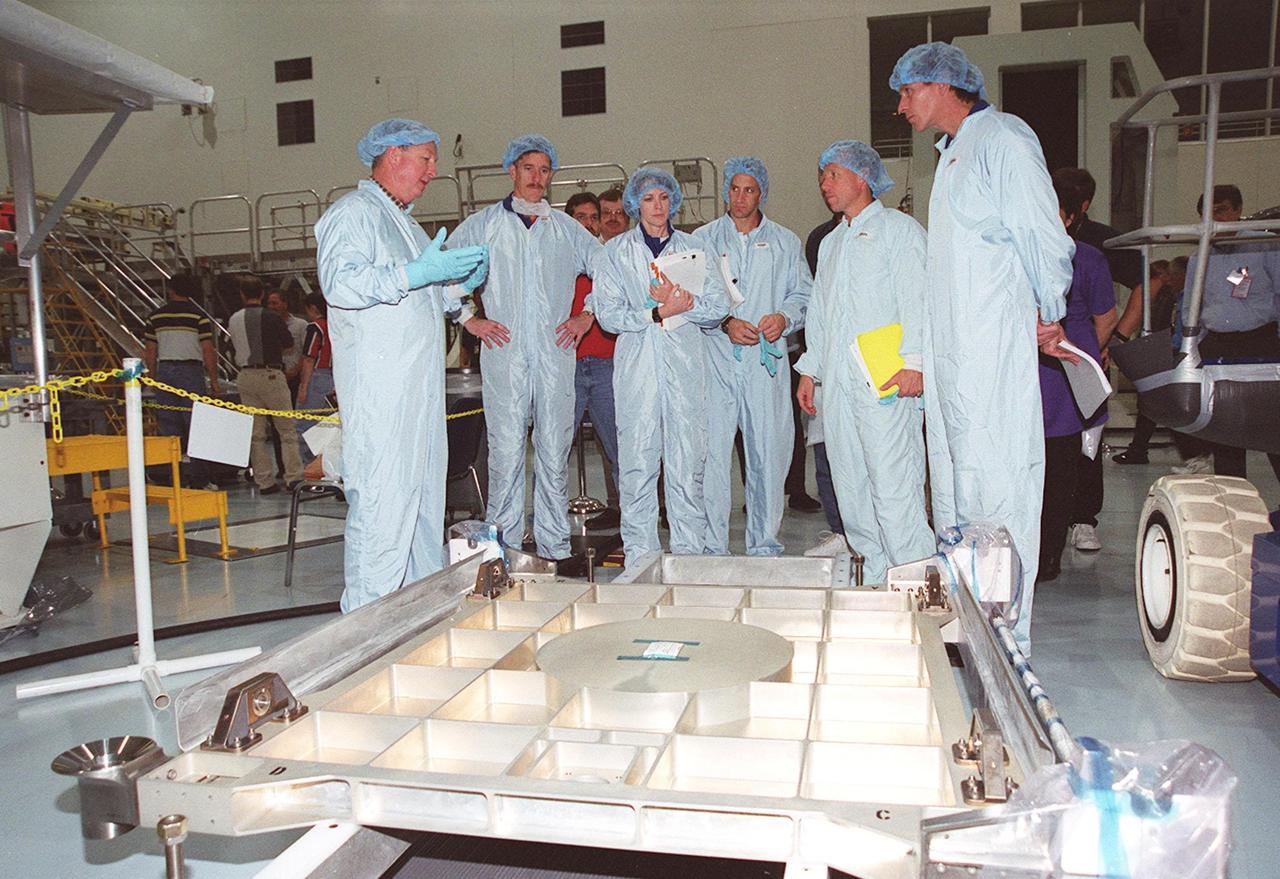 KENNEDY SPACE CENTER, FLA. -- At the Space Station Processing Facility, the STS-104 crew look over equipment as part of Crew Equipment Interface Test activities. Starting second from left are Mission Specialists James F. Reilly II, Janet L. Kavandi, Pilot Charles O. Hobaugh, Commander Steven Lindsey and Mission Specialist Michael L. Gernhardt. The STS-104 mission will carry the Joint Airlock Module to the International Space Station. The U.S.-made module will allow astronauts and cosmonauts in residence on the Station to perform future spacewalks without the presence of a Space Shuttle. The module, which comprises a crew lock and an equipment lock, will be connected to the starboard (right) side of Node 1 Unity. Atlantis will also carry oxygen and nitrogen storage tanks, vital to operation of the Joint Airlock, on a Spacelab Logistics Double Pallet in the payload bay. The tanks, to be installed on the perimeter of the Joint Module during the mission’s spacewalks, will support future spacewalk operations and experiments plus agument the resupply system for the Station’s Service Module