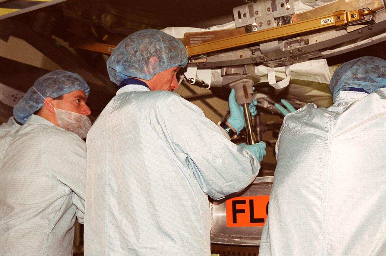 KENNEDY SPACE CENTER, FLA. -- Members of the STS-104 crew practice using tools they will work with on their mission. The crew is at KSC to take part in Crew Equipment Interface Test activities. Seen are (from left) Pilot Charles O. Hobaugh and Mission Specialist Michael L. Gernhardt. Also among the crew are Commander Steven W. Lindsey and Mission Specialists Janet L. Kavandi and James F. Reilly. The mission will carry the Joint Airlock Module to the International Space Station. The U.S.-made module will allow astronauts and cosmonauts in residence on the Station to perform future spacewalks without the presence of a Space Shuttle. The module, which comprises a crew lock and an equipment lock, will be connected to the starboard (right) side of Node 1 Unity. Atlantis will also carry oxygen and nitrogen storage tanks, vital to operation of the Joint Airlock, on a Spacelab Logistics Double Pallet in the payload bay. The tanks, to be installed on the perimeter of the Joint Module during the mission’s spacewalks, will support future spacewalk operations and experiments plus augment the resupply system for the Station’s Service Module