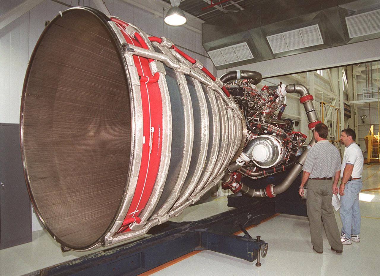 KENNEDY SPACE CENTER, FLA. -- Looking over the upgraded Space Shuttle main engine (block 2 engine) in the Space Shuttle Main Engine Processing Facility are Bob Petrie (left) and Mike Cosgrove (right). Both are with Boeing/Rocketdyne. The new engine will be installed for its first flight on the orbiter Atlantis, on mission STS-104. The Block II Main Engine configuration is manufactured by Boeing Rocketdyne in Canoga Park, Calif., and includes a new Pratt & Whitney high-pressure fuel turbo pump. Engine improvements are managed by NASA’s Marshall Space Flight Center in Huntsville, Ala. Each Space Shuttle Main Engine is 14 feet (4.3 meters) long, weighs about 7,000 pounds (3,175 kilograms), and is 7.5 feet (2.3 meters) in diameter at the end of the nozzle