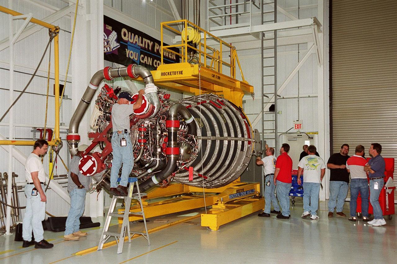 Workers in the Space Shuttle Main Engine Processing Facility prepare a new Space Shuttle main engine (block 2 engine) for its move to the Orbiter Processing Facility. The engine will be installed for its first flight on the orbiter Atlantis, on mission STS-104. The Block II Main Engine configuration is manufactured by Boeing Rocketdyne in Canoga Park, Calif., and includes a new Pratt & Whitney high-pressure fuel turbo pump. Engine improvements are managed by NASA’s Marshall Space Flight Center in Huntsville, Ala. Each Space Shuttle Main Engine is 14 feet (4.3 meters) long, weighs about 7,000 pounds (3,175 kilograms), and is 7.5 feet (2.3 meters) in diameter at the end of the nozzle. <font