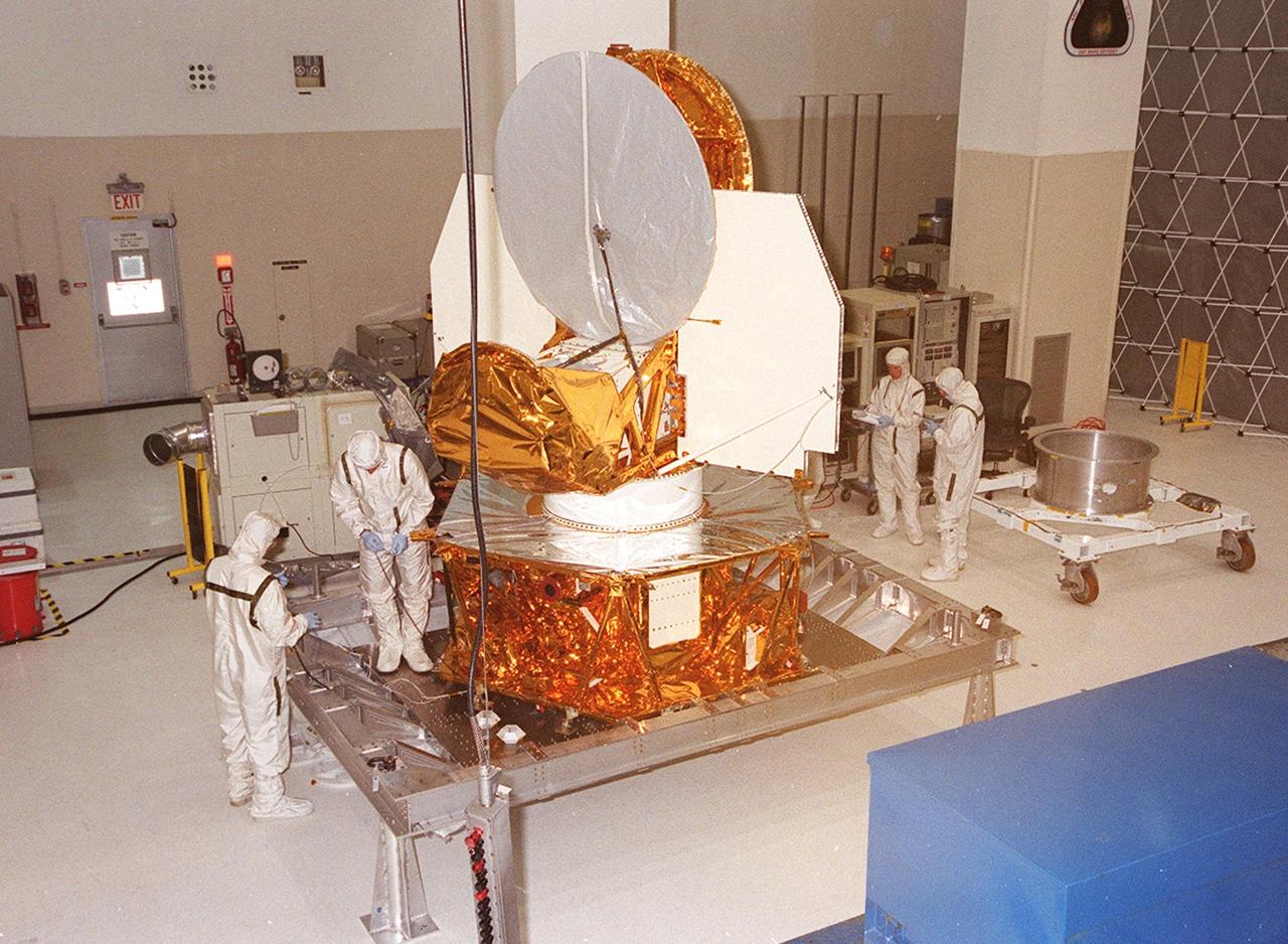 KENNEDY SPACE CENTER, FLA. -- The Microwave Anisotropy Probe (MAP) is worked on in the Spacecraft Assembly and Encapsulation Facility 2. Several milestones must be completed while MAP is at SAEF-2, including antenna installations, solar array installation, solar array deployment and illumination testing, a spacecraft comprehensive performance test, fueling with hydrazine propellant and a spin balance test. MAP will then be ready for integration with the solid propellant Payload Assist Module upper stage booster. MAP is scheduled for launch June 30 from Cape Canaveral Air Force Station on a Delta II rocket into a lunar-assisted trajectory to the Sun-Earth for a 27-month mission. The MAP instrument consists of a set of passively cooled microwave radiometers with 1.4x 1.6-meter diameter primary reflectors to provide the desired angular resolution. MAP measures small fluctuations in the temperature of the cosmic microwave background radiation to an accuracy of one millionth of a degree These measurements should reveal the size, matter content, age, geometry and fate of the universe. They will also reveal the primordial structure that grew to form galaxies and will test ideas about the origins of these primordial structures. The MAP instrument will be continuously shaded from the Sun, Earth, and Moon by the spacecraft. It is a product of Goddard Space Flight Center in partnership with Princeton University