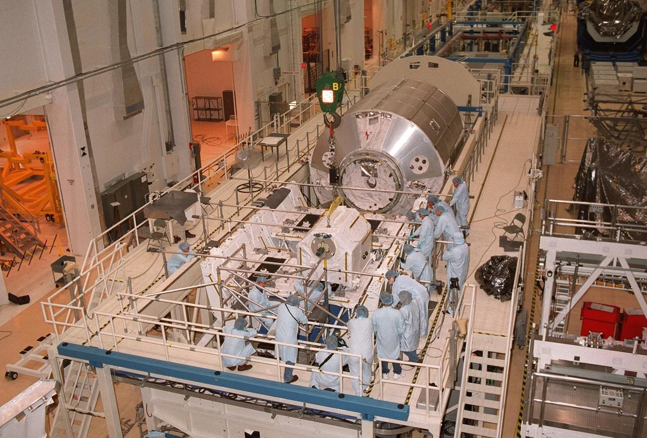 KENNEDY SPACE CENTER, FLA. -- In the Operations and Checkout Building, workers check out the placement of one of four gas tanks on the Spacelab Logistics Double Pallet. Part of the STS-104 payload, the storage tanks two gaseous oxygen and two gaseous nitrogen comprise the high pressure gas assembly that will be attached to the Joint Airlock Module during two spacewalks. The tanks will support future spacewalk operations from the Station and augment the Service Module gas resupply system