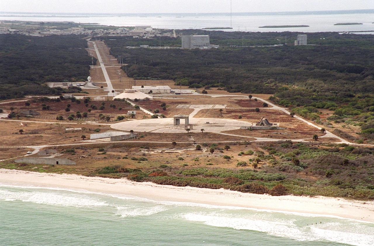 This aerial view of the dismantled Launch Pad 34 at Cape Canaveral Air Force Station stretches from the Atlantic Ocean in the foreground to the Banana River at the top. The round blockhouse is in the middle, and Phillips Parkway, which runs southwest to northeast, runs toward the river