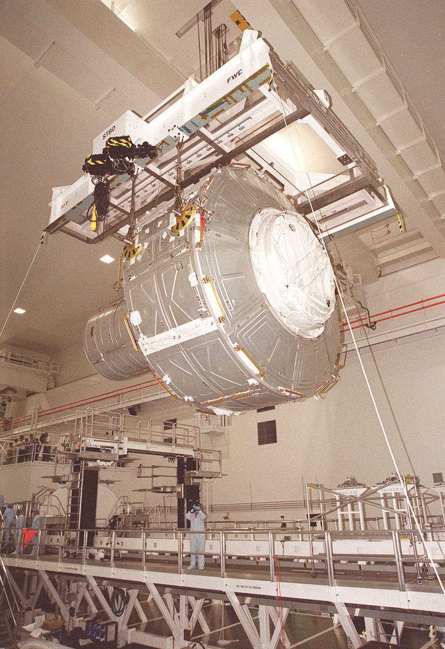 KENNEDY SPACE CENTER, FLA. -- In the Space Station Processing Facility, the Joint Airlock Module is lifted from its workstand for a transfer to the payload canister. The airlock will be installed in the payload bay of Atlantis for mission STS-104 to the International Space Station. The airlock is a pressurized flight element consisting of two cylindrical chambers attached end-to-end by a connecting bulkhead and hatch. Once installed and activated, the airlock becomes the primary path for spacewalk entry to and departure from the Space Station for U.S. spacesuits, which are known as Extravehicular Mobility Units, or EMUs. In addition, the Joint Airlock is designed to support the Russian Orlan spacesuit for EVA activity. STS-104 is scheduled for launch June 14 from Launch Pad 39B