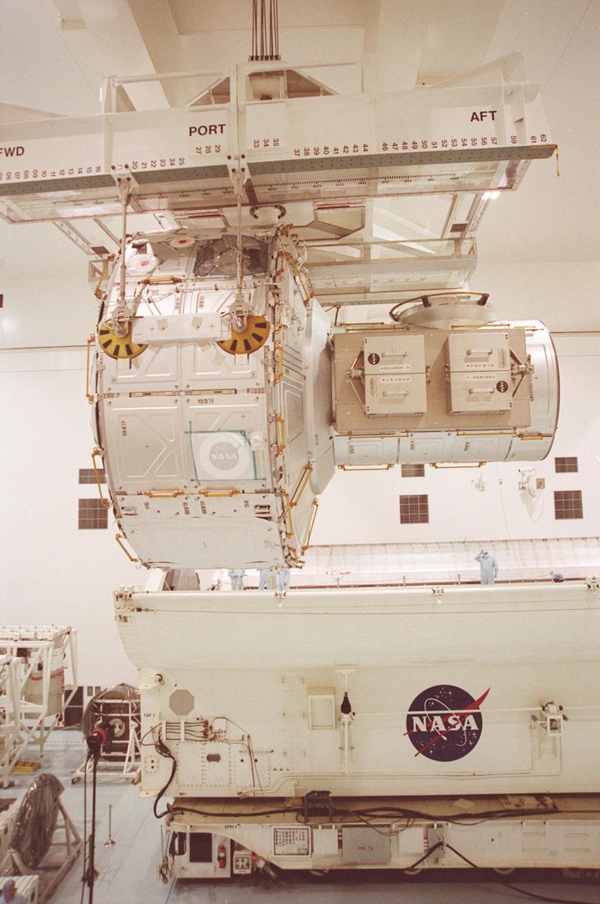 KENNEDY SPACE CENTER, FLA. -- In the Space Station Processing Facility, the Joint Airlock Module is moved closer to the payload canister. The airlock will be installed in the payload bay of Atlantis for mission STS-104 to the International Space Station. The airlock is a pressurized flight element consisting of two cylindrical chambers attached end-to-end by a connecting bulkhead and hatch. Once installed and activated, the Airlock becomes the primary path for spacewalk entry to and departure from the Space Station for U.S. spacesuits, which are known as Extravehicular Mobility Units, or EMUs. In addition, the Joint Airlock is designed to support the Russian Orlan spacesuit for EVA activity. STS-104 is scheduled for launch June 14 from Launch Pad 39B