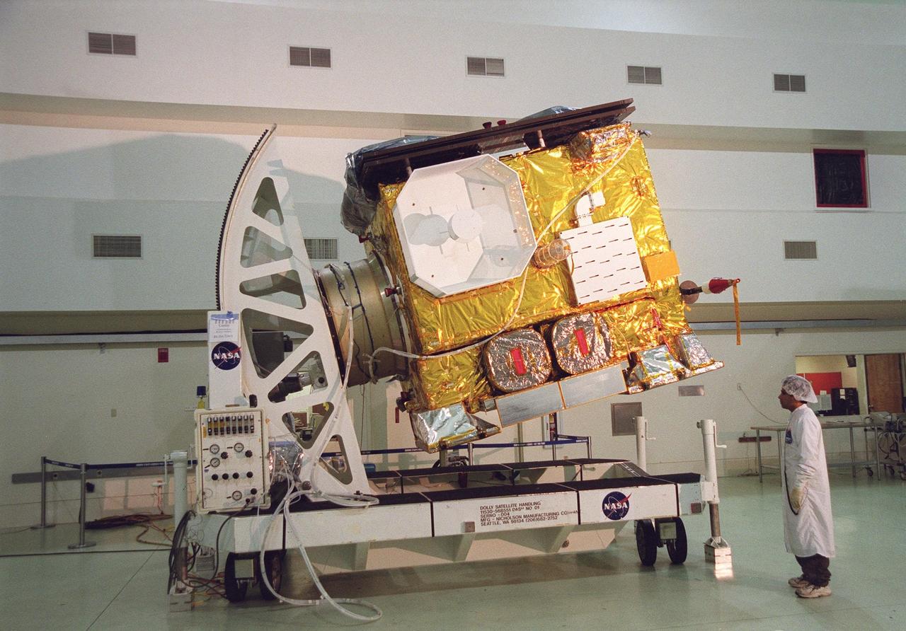 The newest Geostationary Operational Environmental Satellite-M (GOES-M) satellite is rotated at Astrotech, in Titusville for the media who are there to see the last in the current series of advanced geostationary weather satellites in service. GOES-M has a new instrument not on earlier spacecraft, a Solar X-ray Imager that can be used in forecasting space weather, the effects of solar storms that create electromagnetic disturbances on earth that affect other satellites, communications and power grids. GOES is scheduled to launch from Cape Canaveral Air Force Station on an Atlas II rocket in July