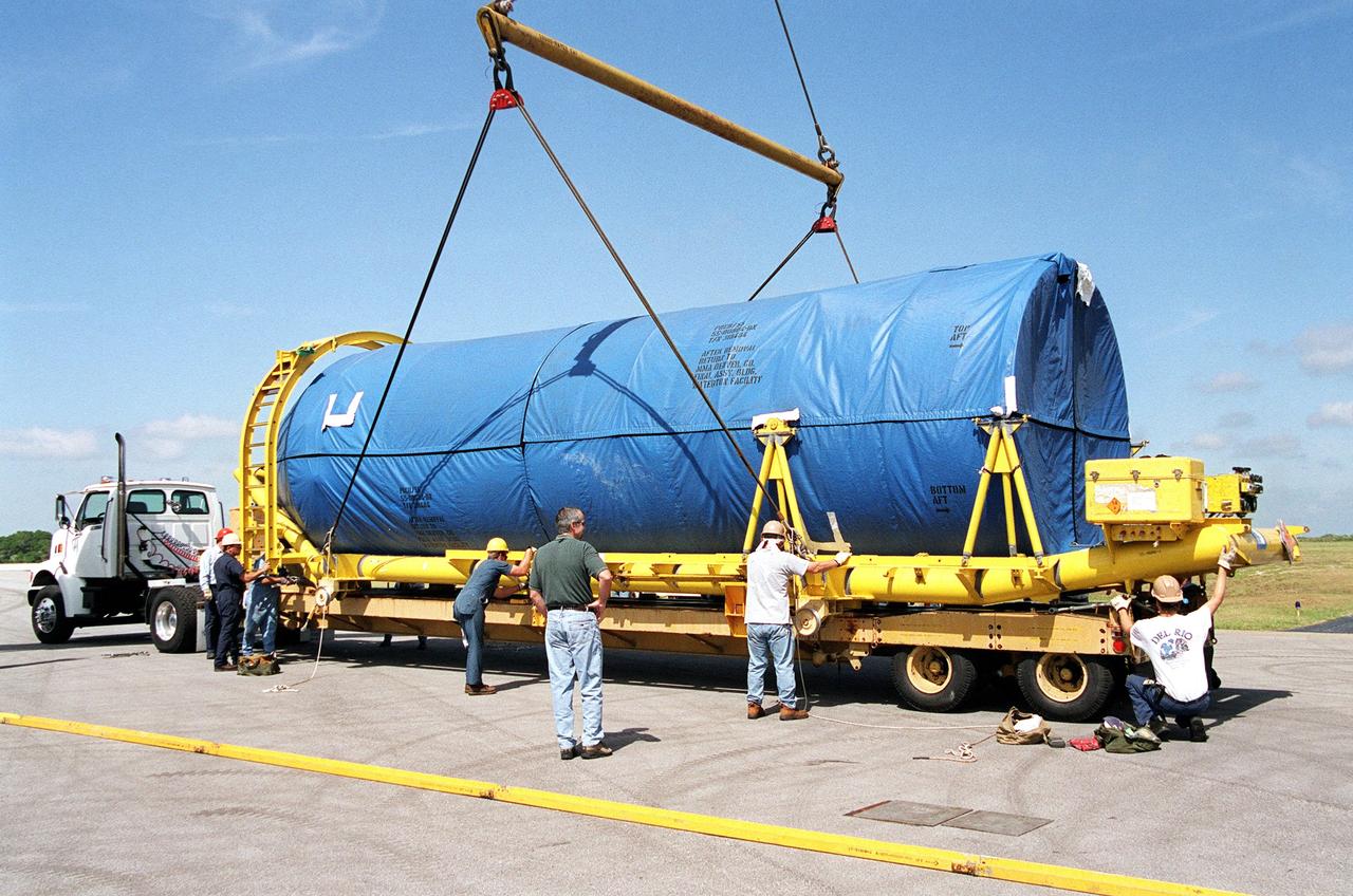 Workers supervise the off-loading of segments of a Lockheed Martin Atlas II rocket at the Skid Strip at Cape Canaveral Air Force Station.; The rocket will be used to launch the Geostationary Operational Environmental Satellite-M (GOES-M), the latest in the current series of advanced geostationary weather satellites in service.; GOES-M is being prepared for launch at the Astrotech Space Operations facility located in the Spaceport Florida Industrial Park in Titusville, Fla. The launch is scheduled for July 15 from Pad 36-A, Cape Canaveral Air Force Station