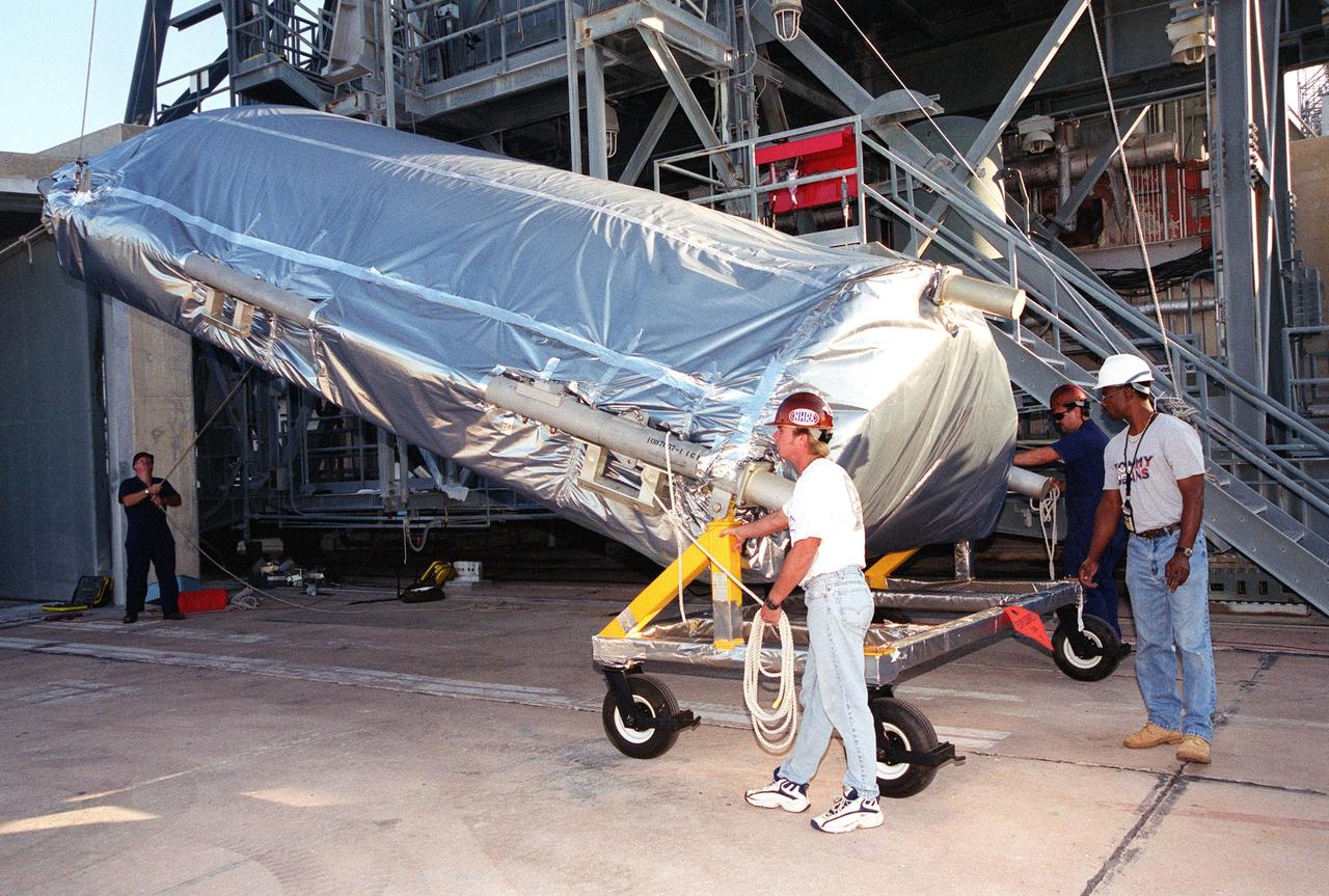 At the gantry on Complex 17-A, Cape Canaveral Air Force Station, the fairing for the Microwave Anisotropy Probe (MAP) spacecraft is raised for its lift to the White Room. There it will wait for the arrival of the spacecraft. MAP is scheduled for launch on June 30 aboard a Boeing Delta II rocket. The launch will place MAP into a lunar-assisted trajectory to the Sun-Earth for a 27-month mission. The probe will measure small fluctuations in the temperature of the cosmic microwave background radiation to an accuracy of one millionth of a degree. These measurements should reveal the size, matter content, age, geometry and fate of the universe. They will also reveal the primordial structure that grew to form galaxies and will test ideas about the origins of these primordial structures. The MAP instrument will be continuously shaded from the Sun, Earth, and Moon by the spacecraft. The probe is a product of Goddard Space Flight Center in partnership with Princeton University
