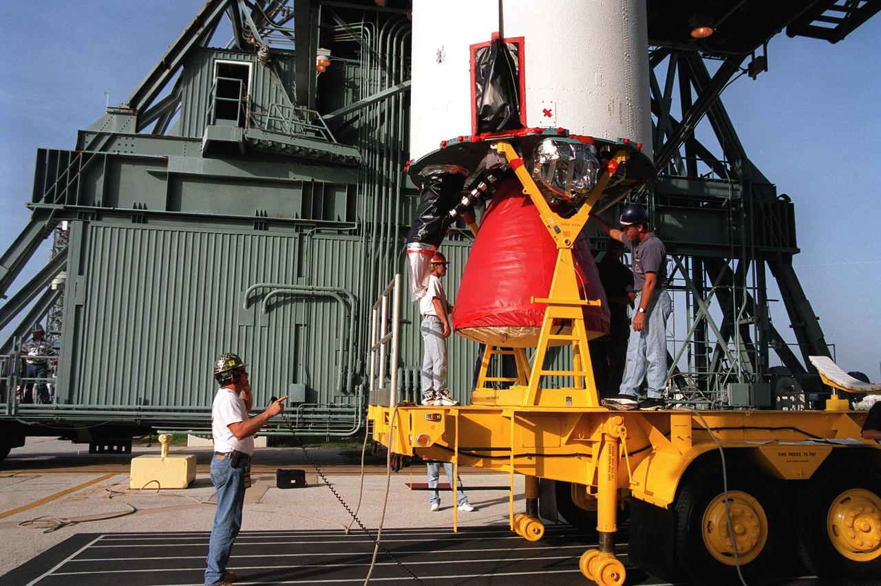 KENNEDY SPACE CENTER, Fla. -- On Launch Complex 17A, Cape Canaveral Air Force Station, workers prepare to disconnect the first stage of a Boeing Delta II rocket from the transporter. The rocket will propel the Genesis spacecraft on a journey to capture samples of the ions and elements in the solar wind and return them to Earth for scientists to use to determine the exact composition of the Sun and the solar system's origin. NASA’s Genesis project in managed by the Jet Propulsion Laboratory in Pasadena, Calif. Lockheed Martin Astronautics built the Genesis spacecraft for NASA in Denver, Colo. The launch is scheduled for July 30 at 12:36 p.m. EDT