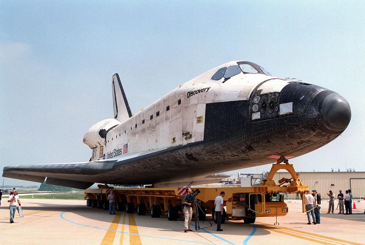 KENNEDY SPACE CENTER, Fla. -- Orbiter Discovery backs out of Orbiter Processing Facility bay 2 atop its transporter for the short trip to the Vehicle Assembly Building. There it will be mated with its external tank and solid rocket boosters for its launch on mission STS-105. The payload on this 11th mission to the International Space Station includes the Multi-Purpose Logistics Module Leonardo, which was built by the Italian Space Agency. Leonardo will be outfitted with 12 racks of experiments and equipment. Launch of Discovery is scheduled for no earlier than Aug. 5, 2001