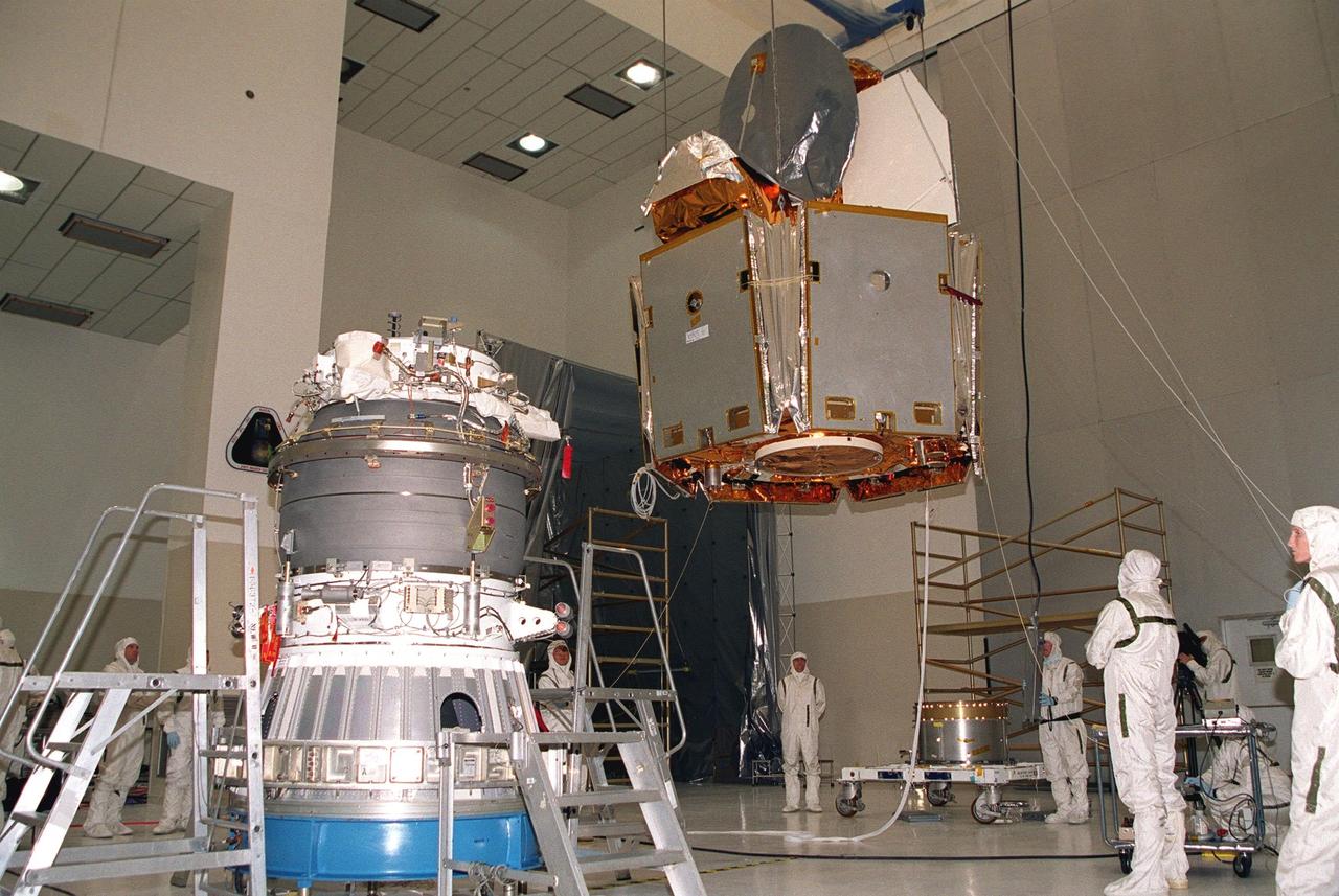 KENNEDY SPACE CENTER, Fla. -- In the Spacecraft Assembly and Encapsulation Facility -2, the Microwave Anisotropy Probe (MAP), suspended by a crane, crosses the facility to the upper stage of the Boeing Delta II rocket. The rocket is scheduled to launch the MAP instrument June 30 into a lunar-assisted trajectory to the Sun-Earth for a 27-month mission. MAP will measure small fluctuations in the temperature of the cosmic microwave background radiation to an accuracy of one millionth of a degree. These measurements should reveal the size, matter content, age, geometry and fate of the universe. They will also reveal the primordial structure that grew to form galaxies and will test ideas about the origins of these primordial structures. The MAP instrument will be continuously shaded from the Sun, Earth, and Moon by the spacecraft. It is a product of Goddard Space Flight Center in partnership with Princeton University