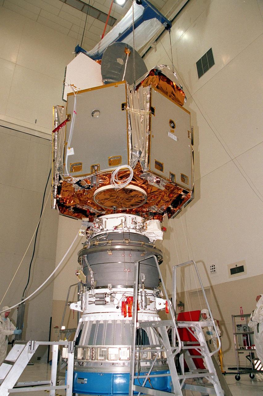KENNEDY SPACE CENTER, Fla. -- The Microwave Anisotropy Probe (MAP) is lowered onto the upper stage of the Boeing Delta II rocket. The rocket is scheduled to launch the MAP instrument June 30 into a lunar-assisted trajectory to the Sun-Earth for a 27-month mission. MAP will measure small fluctuations in the temperature of the cosmic microwave background radiation to an accuracy of one millionth of a degree. These measurements should reveal the size, matter content, age, geometry and fate of the universe. They will also reveal the primordial structure that grew to form galaxies and will test ideas about the origins of these primordial structures. The MAP instrument will be continuously shaded from the Sun, Earth, and Moon by the spacecraft. It is a product of Goddard Space Flight Center in partnership with Princeton University