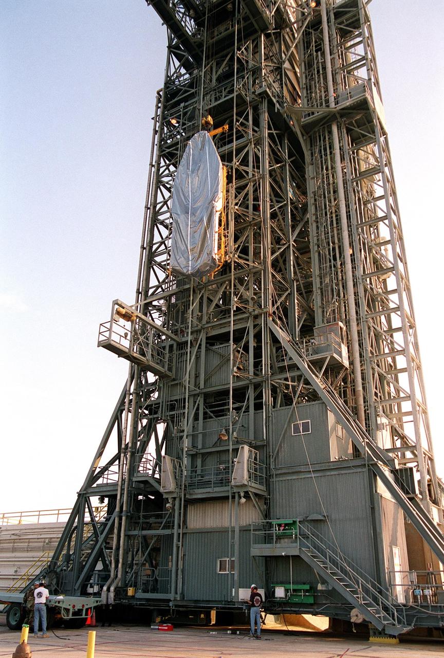 KENNEDY SPACE CENTER, Fla. -- At Launch Complex 17-A, Cape Canaveral Air Force Station, part of the fairing for the Genesis spacecraft is lifted up the gantry. The fairing will encapsulate the spacecraft to protect it during launch aboard a Delta II rocket. Genesis will be on a journey to capture samples of the ions and elements in the solar wind and return them to Earth for scientists to use to determine the exact composition of the Sun and the solar system’s origin. NASA’s Genesis project in managed by the Jet Propulsion Laboratory in Pasadena, Calif. Lockheed Martin Astronautics built the Genesis spacecraft for NASA in Denver, Colo. The launch is scheduled for July 30 at 12:36 p.m. EDT