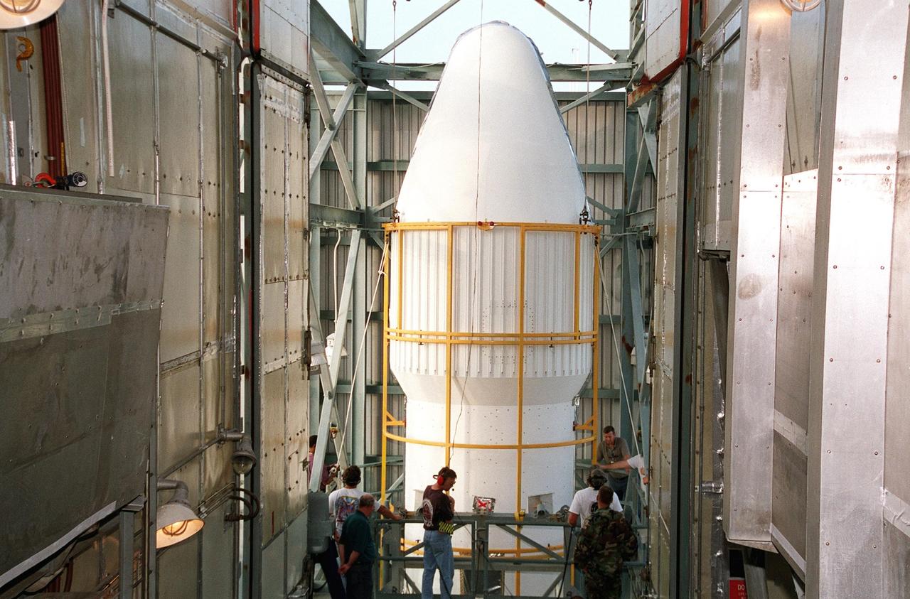 KENNEDY SPACE CENTER, Fla. -- At Launch Complex 17-A, Cape Canaveral Air Force Station, one part of the fairing for the Genesis spacecraft arrives at the top of the gantry. The fairing will encapsulate the spacecraft to protect it during launch aboard a Delta II rocket. Genesis will be on a journey to capture samples of the ions and elements in the solar wind and return them to Earth for scientists to use to determine the exact composition of the Sun and the solar system’s origin. NASA’s Genesis project in managed by the Jet Propulsion Laboratory in Pasadena, Calif. Lockheed Martin Astronautics built the Genesis spacecraft for NASA in Denver, Colo. The launch is scheduled for July 30 at 12:36 p.m. EDT