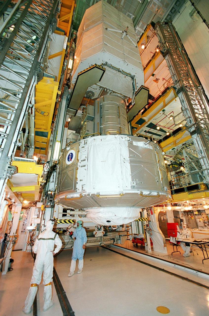 KENNEDY SPACE CENTER, Fla. -- In the Payload Changeout Room, Launch Pad 39B, the Joint Airlock Module (below) and Space Lab Double Pallet (above) are moved into the payload bay of Space Shuttle Atlantis for mission STS-104. The pallet contains two oxygen and two nitrogen High-Pressure Gas Tanks, which will be attached externally to the airlock during two of the STS-104 spacewalks. Once installed and activated, the airlock becomes the primary path for International Space Station spacewalk entry and departure using U.S. spacesuits, which are known as Extravehicular Mobility Units, or EMUs. In addition, the Joint Airlock is designed to support the Russian Orlan spacesuit for EVA activity. Launch of Atlantis is scheduled no earlier than July 12 at 5:04 a.m. EDT