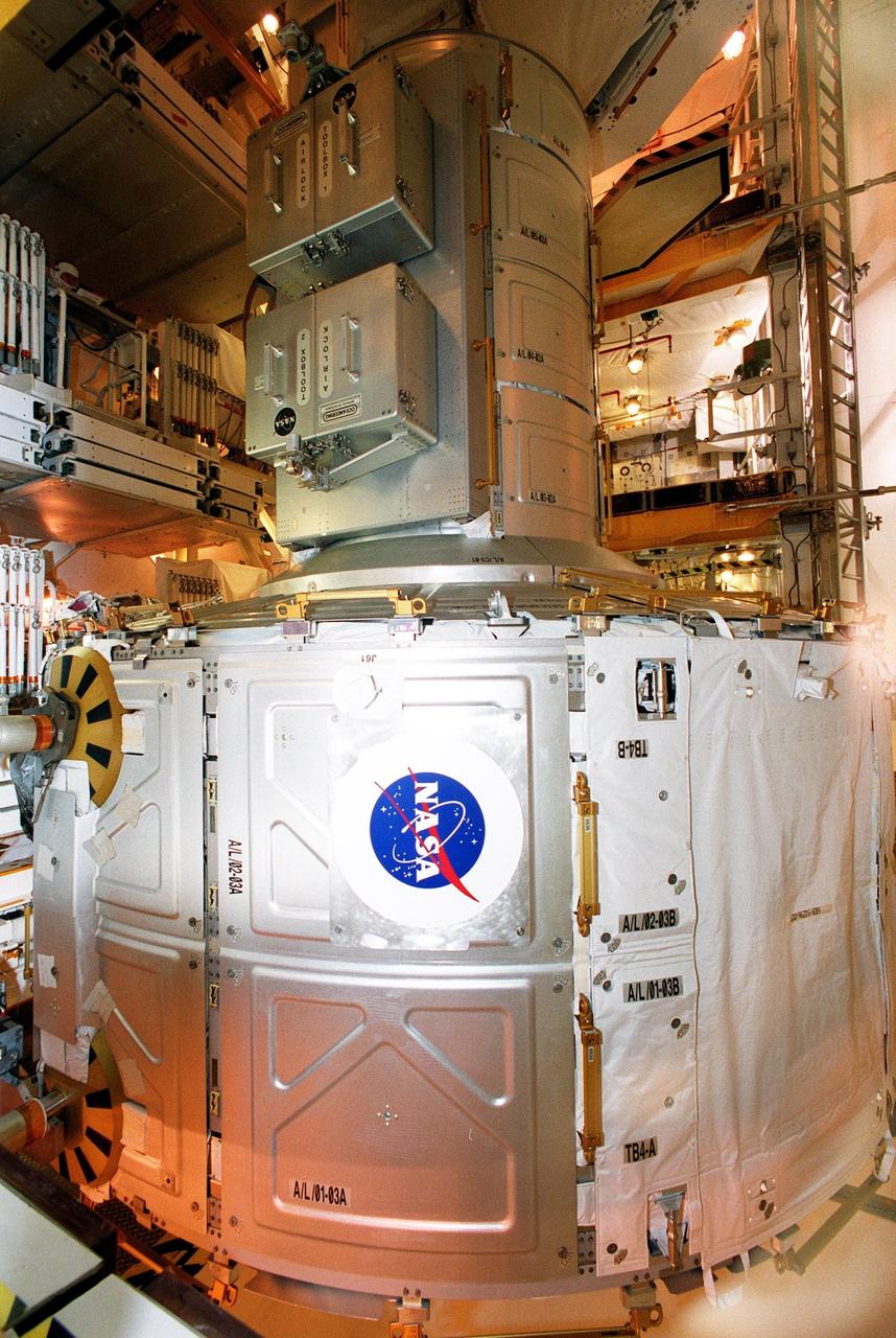KENNEDY SPACE CENTER, Fla. -- The Joint Airlock Module, sporting a NASA logo, is moved toward the payload bay of Space Shuttle Atlantis for mission STS-104. Once installed and activated, the airlock becomes the primary path for International Space Station spacewalk entry and departure using U.S. spacesuits, which are known as Extravehicular Mobility Units, or EMUs. In addition, the Joint Airlock is designed to support the Russian Orlan spacesuit for EVA activity. Launch of Atlantis is scheduled no earlier than July 12 at 5:04 a.m. EDT