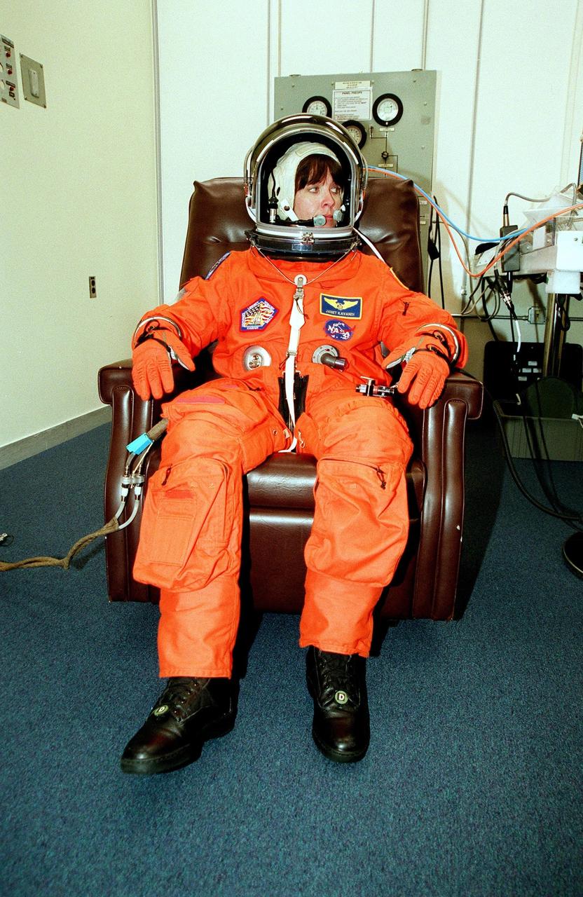 KENNEDY SPACE CENTER, Fla. -- STS-104 Mission Specialist Janet Lynn Kavandi looks at nearby crew members during suit and fit check during Terminal Countdown Demonstration Test (TCDT) activities at KSC. The TCDT provides the crew with emergency egress training, opportunities to inspect their mission payloads in Space Shuttle Atlantis’s payload bay, and simulated countdown exercises. Other crew members participating are Commander Steven W. Lindsey, Pilot Charles O. Hobaugh and Mission Specialists Michael L. Gernhardt and James F. Reilly. The launch of Atlantis on mission STS-104 is scheduled no earlier than July 12 from Launch Pad 39B. The mission is the 10th flight to the International Space Station and carries the Joint Airlock Module
