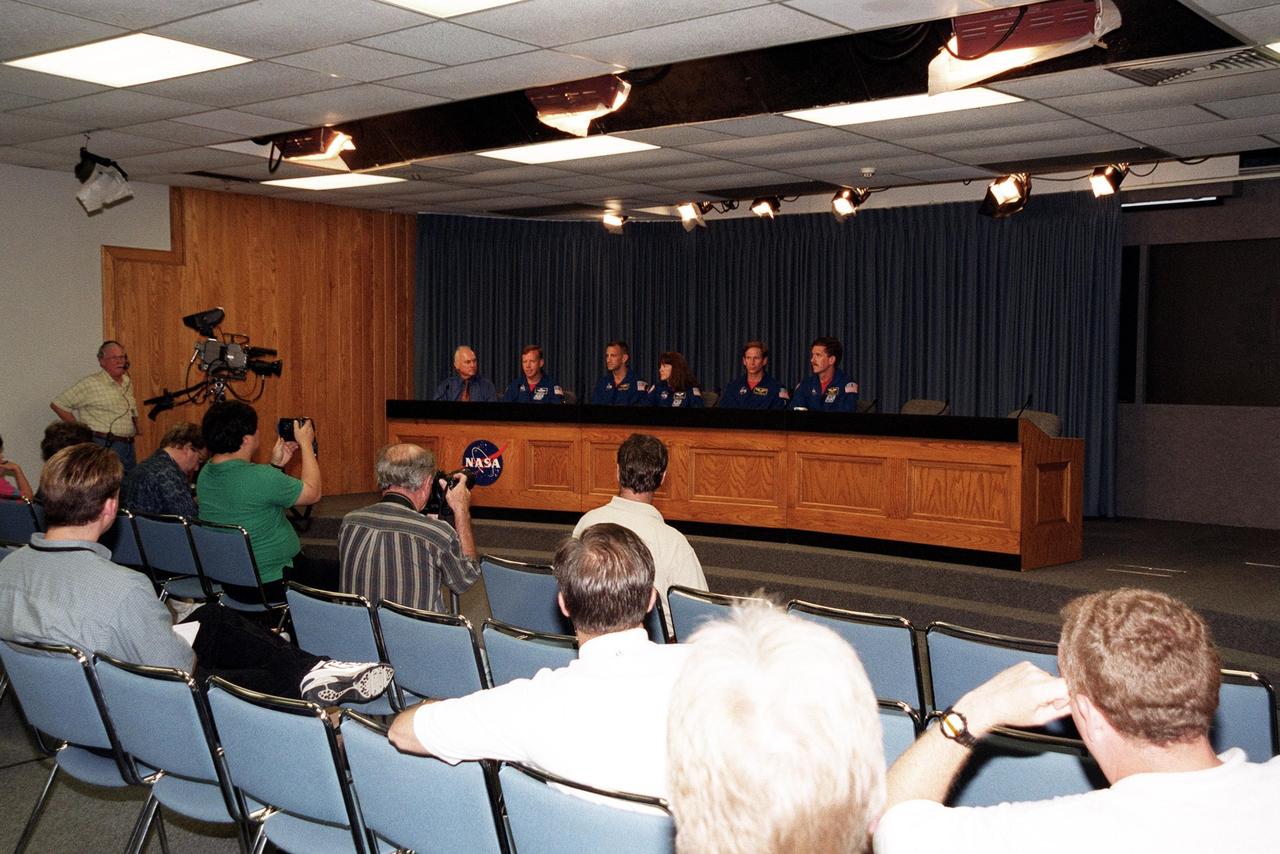 KENNEDY SPACE CENTER, Fla. -- The STS-104 crew responds to questions from the media in the television studio. Seated at far left is moderator Bill Johnson, NASA/KSC TV manager. Beside him, left to right, are Commander Steven W. Lindsey, Pilot Charles O. Hobaugh, and Mission Specialists Janet Lynn Kavandi, Michael L. Gernhardt and James F. Reilly. . The crew is taking part in Terminal Countdown Demonstration Test activities, which include emergency exit training from the orbiter, opportunities to inspect their mission payloads in the orbiter’s payload bay and simulated countdown exercises. The launch of Atlantis on mission STS-104 is scheduled July 12 from Launch Pad 39B. The mission is the 10th flight to the International Space Station and carries the Joint Airlock Module