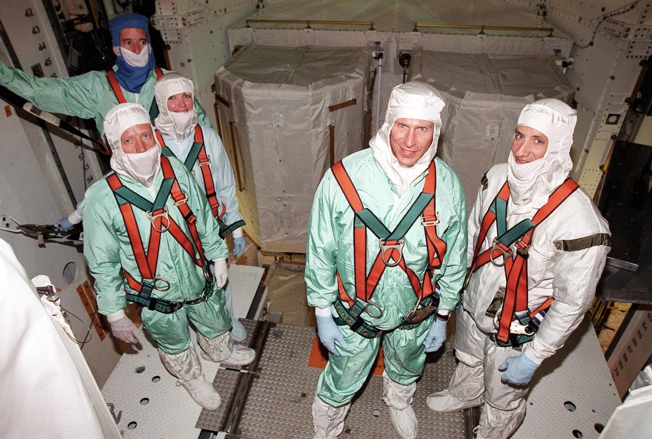 KENNEDY SPACE CENTER, Fla. -- During payload walkdown at Launch Pad 39B, the STS-104 crew pause for a photo. At left are Commander Steven W. Lindsey (front), Mission Specialist Janet Lynn Kavandi (center) and Mission Specialist James F. Reilly (back). At right are Mission Specialist Michael L. Gernhardt and Pilot Charles O. Hobaugh. The crew is taking part in Terminal Countdown Demonstration Test activities, which include emergency exit training from the orbiter, opportunities to inspect their mission payloads in the orbiter’s payload bay and simulated countdown exercises. The launch of Atlantis on mission STS-104 is scheduled July 12 from Launch Pad 39B. The mission is the 10th flight to the International Space Station and carries the Joint Airlock Module