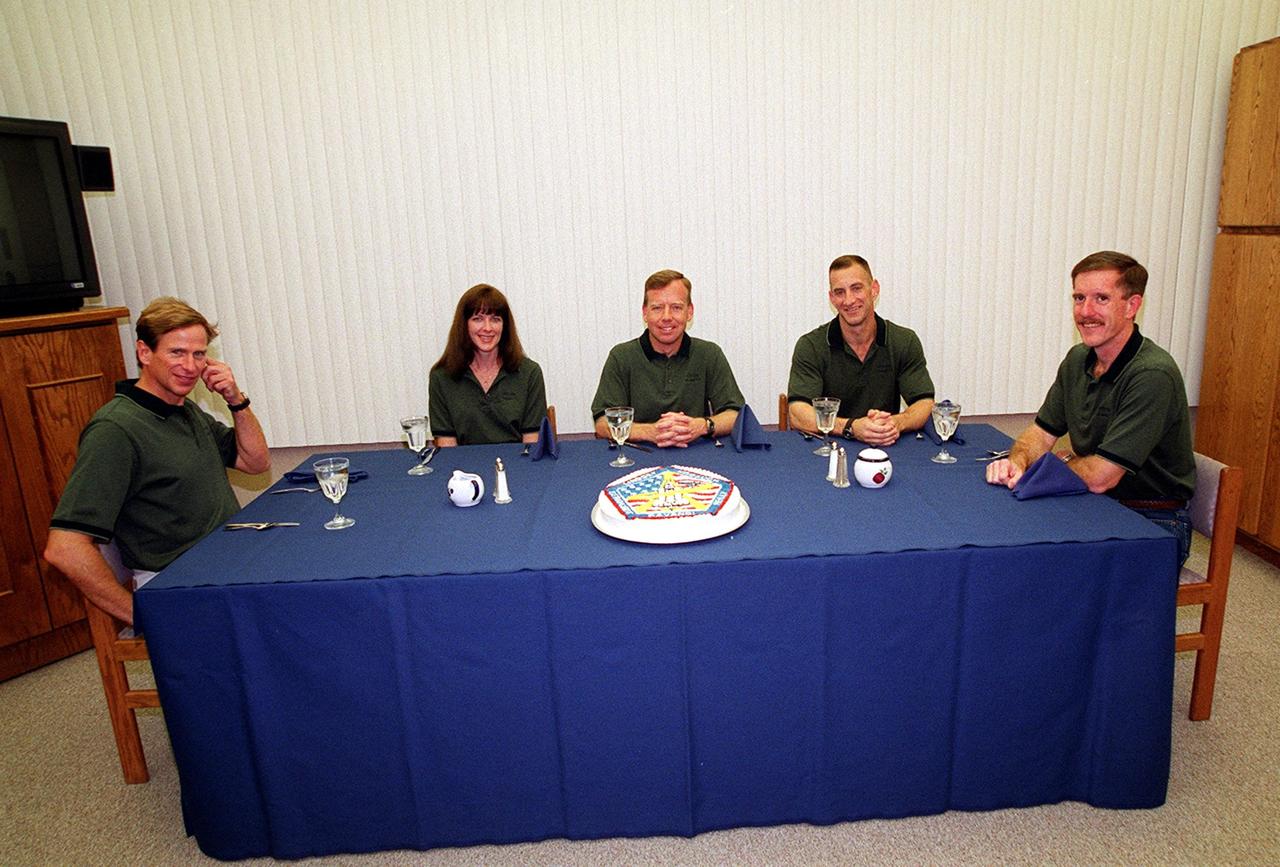 KENNEDY SPACE CENTER, Fla. -- The STS-104 crew finish their final meal of the day before launch. Seated from left are Mission Specialists Michael L. Gernhardt and Janet Lynn Kavandi, Commander Steven W. Lindsey, Pilot Charles O. Hobaugh and Mission Specialist James F. Reilly. The launch of Space Shuttle Atlantis on mission STS-104 is targeted for 5:04 a.m., July 12, from Launch Pad 39B. The primary payload on the mission is the joint airlock module, which will be added to the International Space Station. The airlock will be the primary path for Space Station spacewalk entry and departure for U.S. spacesuits, and will also support the Russian Orlan spacesuit for EVA activity