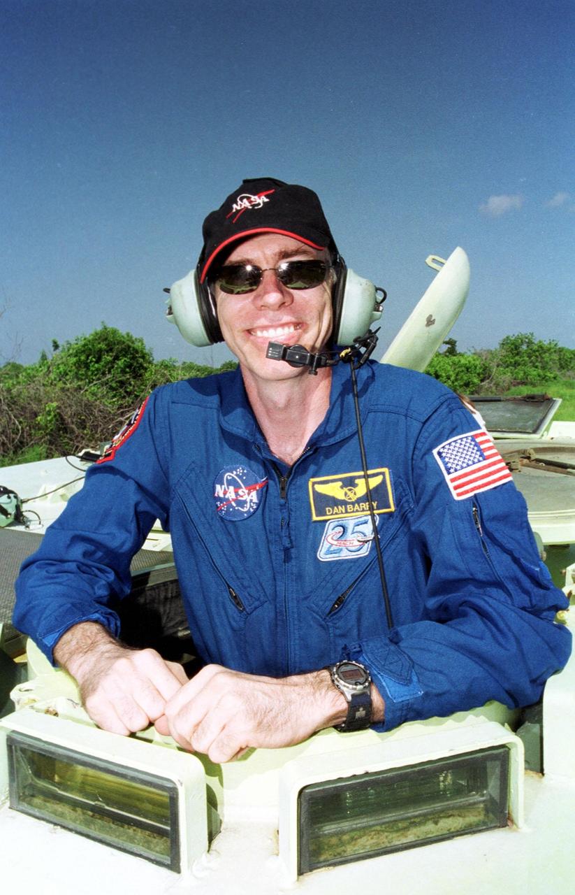 KENNEDY SPACE CENTER, Fla. -- STS-105 Mission Specialist Daniel T. Barry is ready to take the wheel of the M-113 armored personnel carrier that is part of emergency egress training at the pad. The training is part of Terminal Countdown Demonstration Test activities, which also include a simulated launch countdown and familiarization with the payload. Other STS-105 crew members taking part are Commander Scott Horowitz, Pilot Rick Sturckow, and Mission Specialist Patrick Forrester; and the Expedition Three crew, Commander Frank Culbertson, and cosmonauts Vladimir Nikolaevich Dezhurov and Mikhail Tyurin. Mission STS-105 will be transporting the Expedition Three crew, several payloads and scientific experiments to the International Space Station aboard Space Shuttle Discovery. The current Expedition Two crew members on the Station will return to Earth on Discovery. Launch of Discovery is scheduled no earlier than Aug. 9, 2001