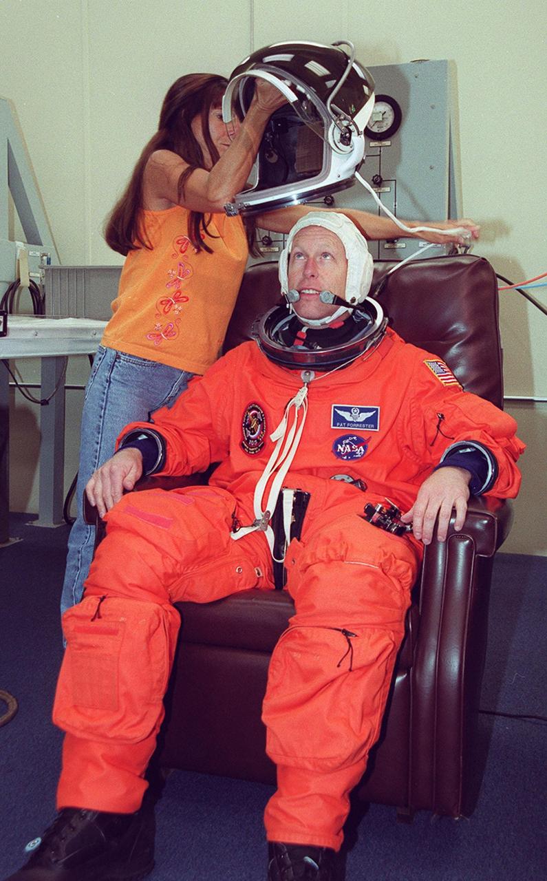 KENNEDY SPACE CENTER, Fla. -- STS-105 Mission Specialist Patrick Forrester waits to don his helmet during suit fit check as part of Terminal Countdown Demonstration Test activities. He and other crew members Commander Scott Horowitz, Pilot Rick Sturckow and Mission Specialist Daniel Barry are also taking part in the TCDT, which includes emergency egress training and a simulated launch countdown. Mission STS-105 will be transporting the Expedition Three crew - Commander Frank Culbertson and Vladimir Nikolaevich Dezhurov and Mikhail Tyurin, both with the Russian Aviation and Space Agency - several payloads and scientific experiments to the International Space Station aboard Space Shuttle Discovery. The current Expedition Two crew members on the Station will return to Earth on Discovery. Launch of Discovery is scheduled no earlier than Aug. 9, 2001