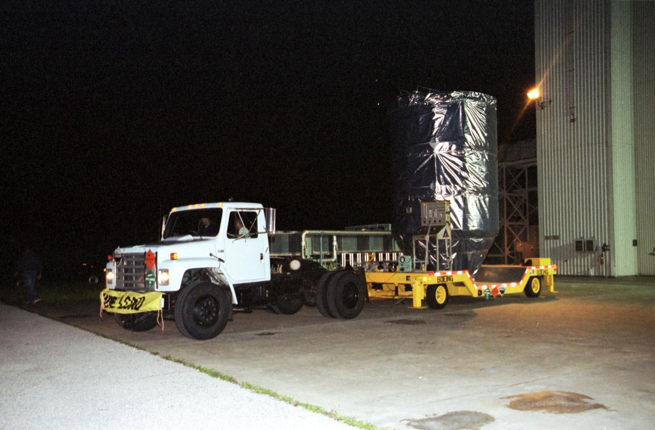 KENNEDY SPACE CENTER, Fla. -- The Genesis spacecraft, enclosed in its protective cover, is transported from the Payload Hazardous Servicing Facility on its way to Launch Complex 17-A, Cape Canaveral Air Force Station. Genesis is 7.5 feet (2.3 meters) long and 6.6 feet (2 meters) wide, with a wingspan of solar array 26 feet (7.9 meters) tip to tip. Genesis will be on a robotic NASA space mission to catch a wisp of the raw material of the Sun and return it to Earth with a spectacular mid-air helicopter capture. The sample return capsule is 4.9 feet (1.5 meters) in diameter and 52 inches (1.31 meters) tall. The mission’s goal is to collect and return to Earth just 10 to 20 micrograms -- or the weight of a few grains of salt -- of solar wind, invisible charged particles that flow outward from the Sun. This treasured smidgen of the Sun will be preserved in a special laboratory for study by scientists over the next century in search of answers to fundamental questions about the exact composition of our star and the birth of our solar system. The Genesis launch is scheduled for 12:36 p.m. EDT on July 30 from CCAFS