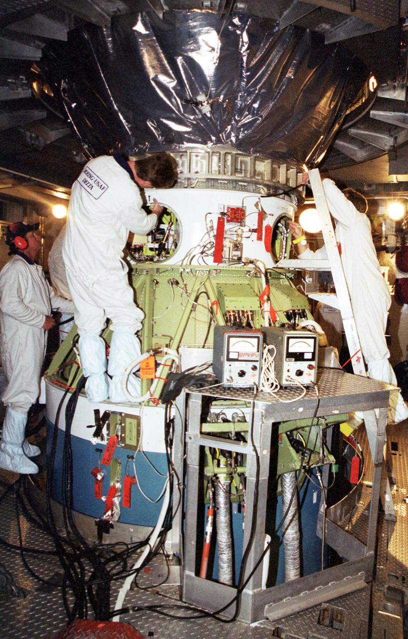 KENNEDY SPACE CENTER, Fla. -- At Launch Complex 17-A, Cape Canaveral Air Force Station, the Genesis spacecraft is lowered into place on the Boeing Delta II rocket. Genesis will be on a robotic NASA space mission to catch a wisp of the raw material of the Sun and return it to Earth with a spectacular mid-air helicopter capture. The sample return capsule is 4.9 feet (1.5 meters) in diameter and 52 inches (1.31 meters) tall. The mission’s goal is to collect and return to Earth just 10 to 20 micrograms -- or the weight of a few grains of salt -- of solar wind, invisible charged particles that flow outward from the Sun. This treasured smidgen of the Sun will be preserved in a special laboratory for study by scientists over the next century in search of answers to fundamental questions about the exact composition of our star and the birth of our solar system. The Genesis launch is scheduled for 12:36 p.m. EDT on July 30 from CCAFS
