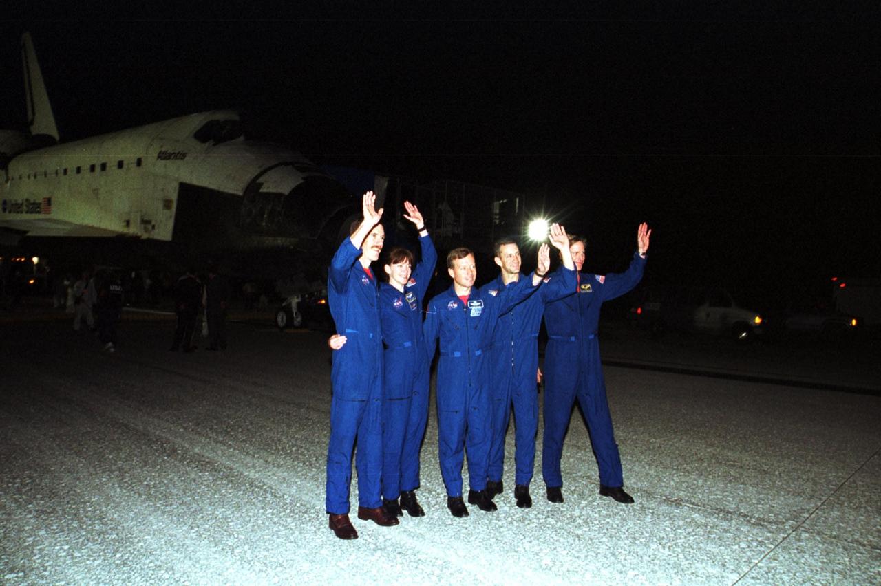 KENNEDY SPACE CENTER, Fla. -- The STS-104 crew wave at onlookers who welcomed them home from their almost 13-day mission to the International Space Station. From left are Mission Specialists James Reilly and Janet Lynn Kavandi, Commander Steven Lindsey, Pilot Charles Hobaugh and Mission Specialist Michael Gernhardt. Atlantis touched down at 11:38:55 p.m. EDT July 24, 2001. The mission delivered the Joint Airlock Module to the Space Station, completing the second phase of the assembly of the Space Station. This is the 18th nighttime landing for a Space Shuttle, the 13th at Kennedy Space Center