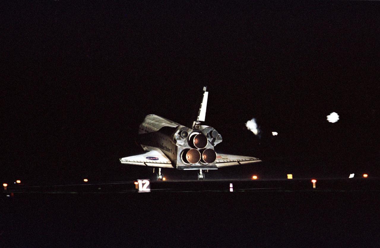 KENNEDY SPACE CENTER, Fla. -- The lights on Runway 15 at KSC’s Shuttle Landing Facility spotlight Atlantis as it touches down, completing a 12-day, 18-hour, 34-minute-long STS-104 mission. Main gear touchdown occurred at 11:38:55 p.m. EDT. At the controls is Commander Steven W. Lindsey. Other crew members on board are Pilot Charles Hobaugh and Mission Specialists Michael Gernhardt, Janet Lynn Kavandi and James F. Reilly. This is the 18th nighttime landing for a Space Shuttle, the 13th at Kennedy Space Center. The mission delivered the Joint Airlock Module to the International Space Station, which was subsequently attached to the Unity Node, completing the second phase of the assembly of the Space Station