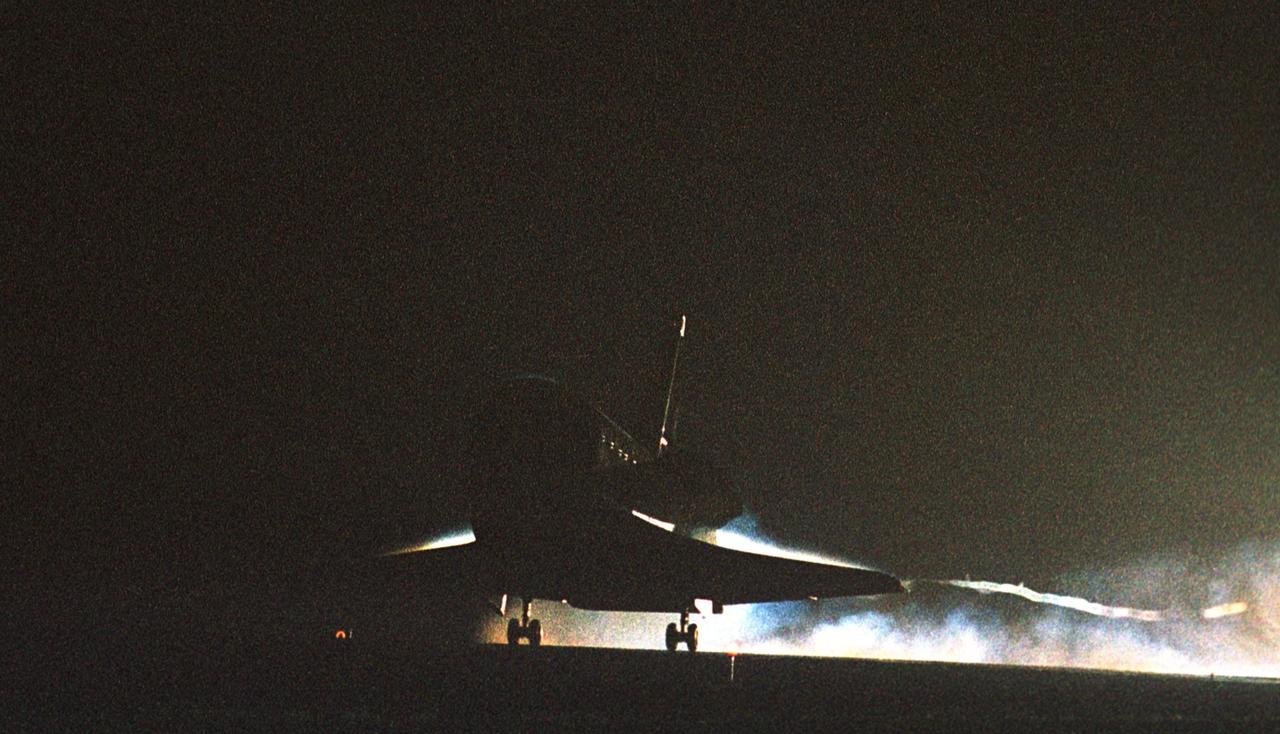 KENNEDY SPACE CENTER, Fla. -- Atlantis touches down on Runway 15 at the Shuttle Landing Facility to complete a 12-day, 18-hour, 34-minute-long STS-104 mission. Main gear touchdown occurred at 11:38:55 p.m. EDT. At the controls is Commander Steven W. Lindsey. Other crew members on board are Pilot Charles Hobaugh and Mission Specialists Michael Gernhardt, Janet Lynn Kavandi and James F. Reilly. This is the 18th nighttime landing for a Space Shuttle, the 13th at Kennedy Space Center. The mission delivered the Joint Airlock Module to the International Space Station, completing the second phase of the assembly of the Space Station
