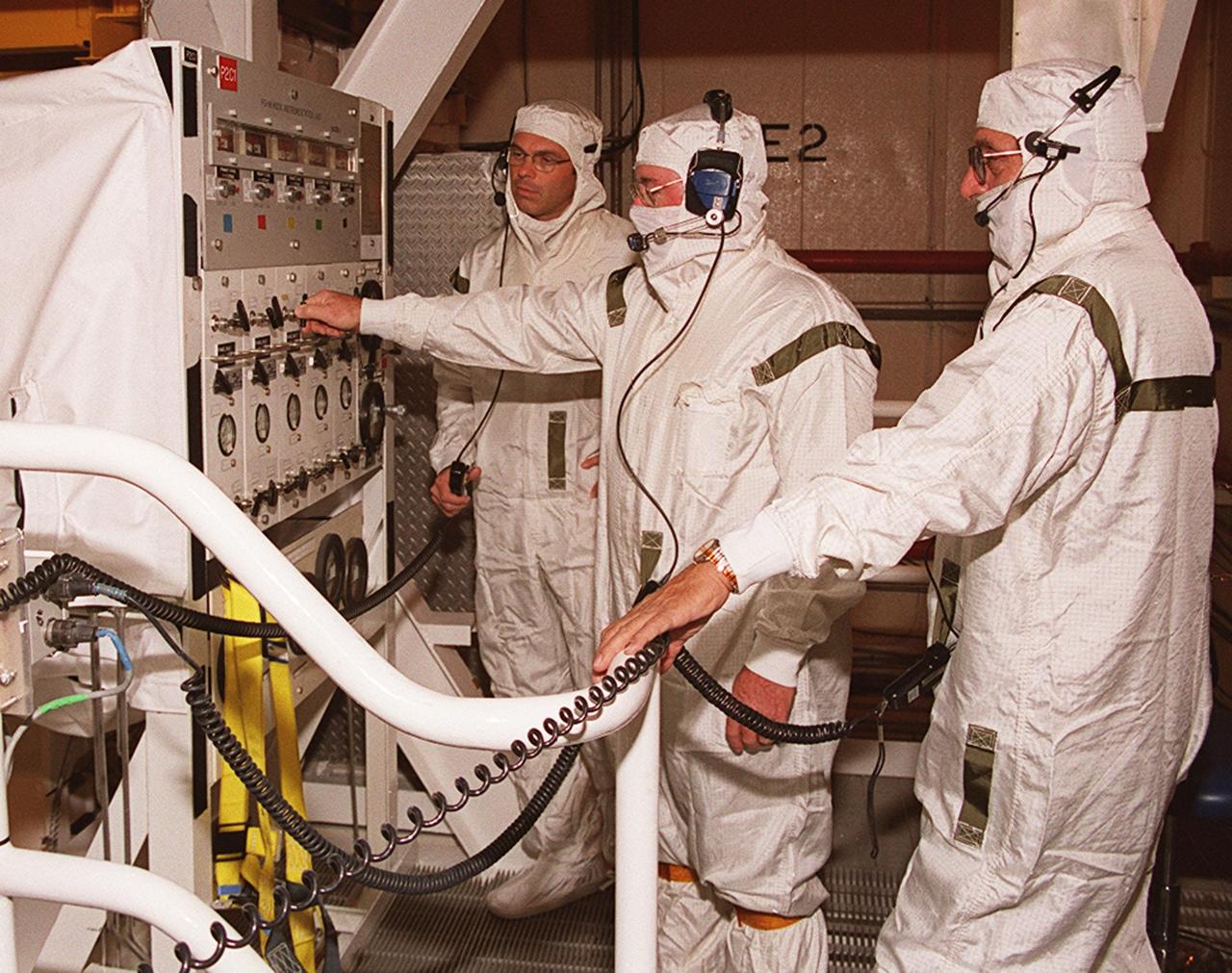 KENNEDY SPACE CENTER, Fla. -- Technicians in the payload changeout room on Launch Pad 39A monitor the controls moving the Multi-Purpose Logistics Module Leonardo out of the payload canister. The MPLM is the primary payload on mission STS-105 to the International Space Station. The mission includes a crew changeover on the Space Station. Expedition Three will be traveling on Discovery to replace Expedition Two, who will return to Earth on board Discovery. Launch of STS-105 is scheduled for Aug. 9