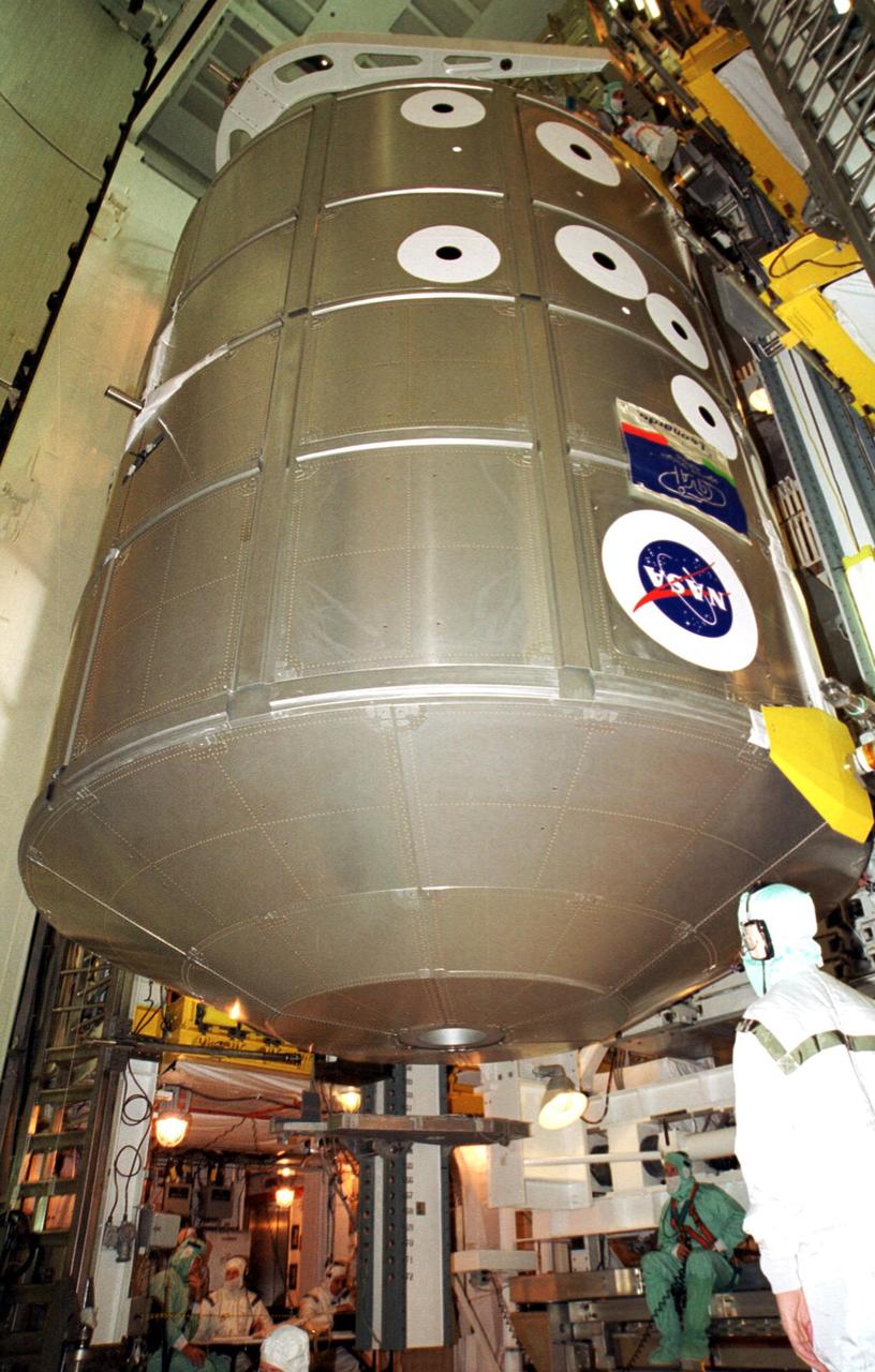KENNEDY SPACE CENTER, Fla. -- From the Payload Changeout Room on Launch Pad 39A, workers move the Multi-Purpose Logistics Module Leonardo via the Payload Ground Handling Mechanism (right) toward Discovery’s payload bay. Leonardo contains supplies and equipment for the International Space Station and its resident crew. Discovery is scheduled to launch Aug. 9, 2001, on mission STS-105