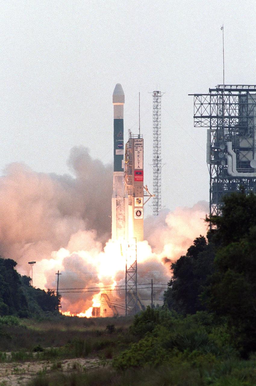 KENNEDY SPACE CENTER, Fla. -- Smoke and steam rolls across Launch Complex 17-A, Cape Canaveral Air Force Station, as the Boeing Delta II rocket propels NASA’s Genesis spacecraft above the launch tower and into the sky. The Genesis/Delta launch occurred on time at 12:13:40 p.m. EDT. Genesis is on a journey to collect and return to Earth just 10 to 20 micrograms of solar wind, invisible charged particles that flow outward from the Sun. The particles will be studied by scientists over the next century to search for answers to fundamental questions about the exact composition of our star and the birth of our solar system