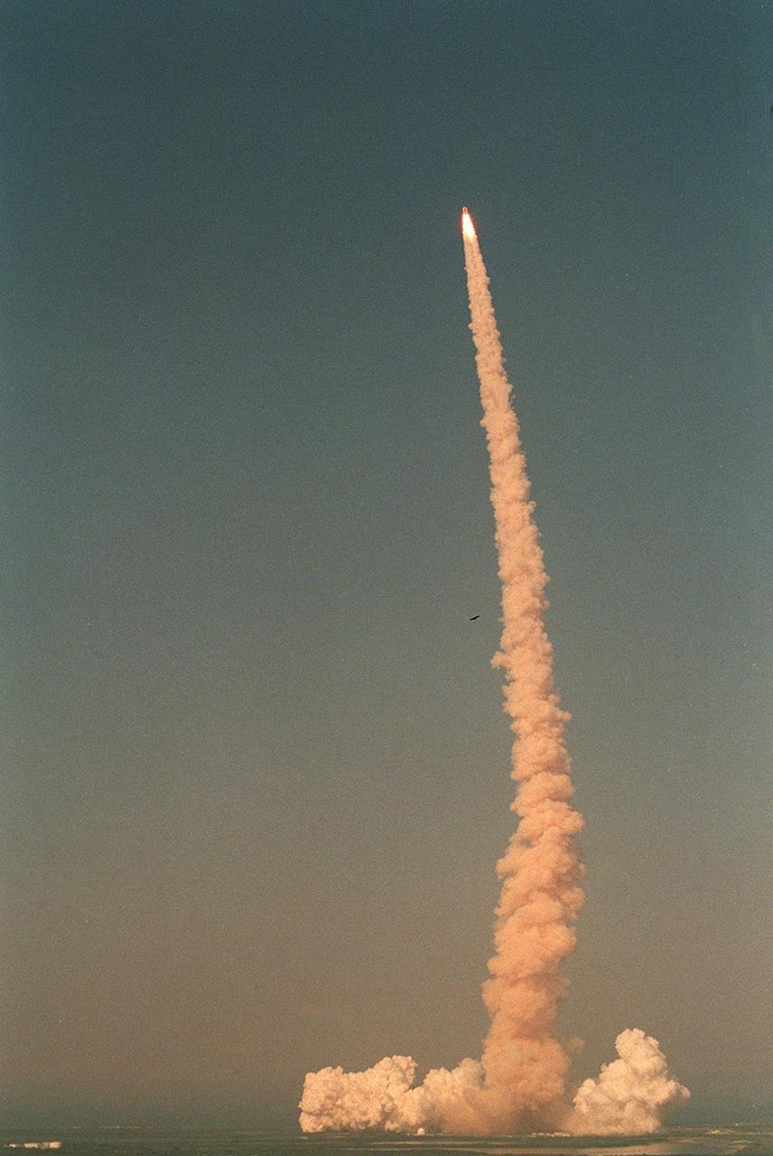 KENNEDY SPACE CENTER, Fla. -- Trailing a fiery-looking column of smoke, Space Shuttle Discovery hurtles into a blue sky on mission STS-105 to the International Space Station. Viewed from the top of the Vehicle Assembly Building, liftoff occurred at 5:10:14 p.m. EDT on this second launch attempt. Launch countdown activities for the 12-day mission were called off Aug. 9 during the T-9 minute hold due to the high potential for lightning, a thick cloud cover and the potential for showers. Besides the Shuttle crew of four, Discovery carries the Expedition Three crew who will replace Expedition Two on the International Space Station. The mission includes the third flight of an Italian-built Multi-Purpose Logistics Module delivering additional scientific racks, equipment and supplies for the Space Station, and two spacewalks. Part of the payload is the Early Ammonia Servicer (EAS) tank, which will be attached to the Station during the spacewalks. The EAS contains spare ammonia for the Station’s cooling system. The three-member Expedition Two crew will be returning to Earth aboard Discovery after a five-month stay on the Station