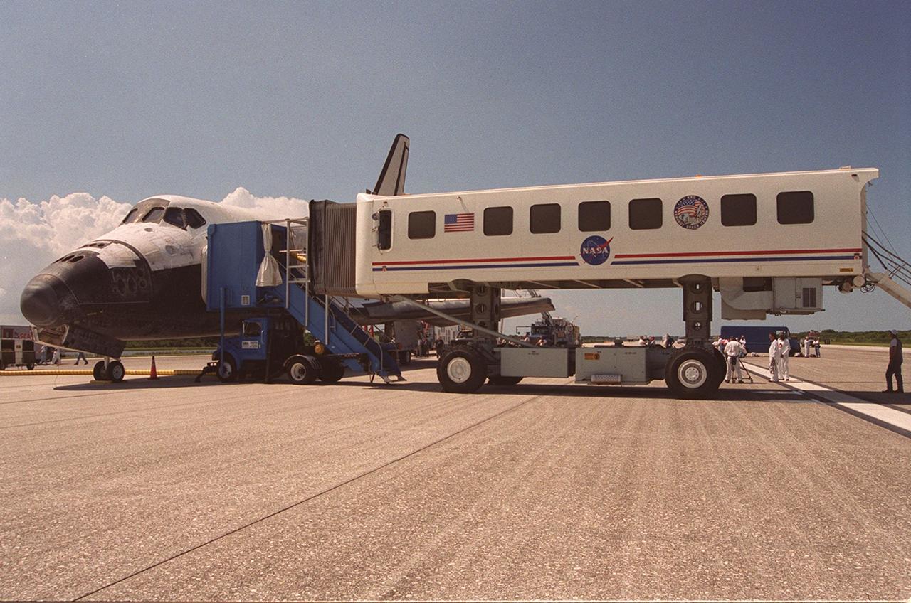 KENNEDY SPACE CENTER, Fla. -- Following mission STS-105, the Crew Transfer Vehicle (CTV) is moved into place beside orbiter Discovery on KSC’s Shuttle Landing Facility runway 15. Both the STS-105 and Expedition Two crews will exit the Space Shuttle into the CTV where they will be given preliminary physical examinations by a physician.  Main gear touchdown was at 2:22:58 p.m. EDT; wheel stop, at 2:24:06 p.m. EDT. The 11-day, 21-hour, 12-minute mission accomplished the goals set for the 11th flight to the International Space Station: swapout of the resident Station crew; delivery of equipment, supplies and scientific experiments; and installation of the Early Ammonia Servicer and heater cables for the S0 truss on the Station. Discovery traveled 4.3 million miles on its 30th flight into space, the 106th mission of the Space Shuttle program. Out of five missions in 2001, the landing was the first to occur in daylight at KSC