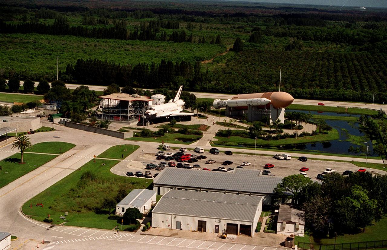 KENNEDY SPACE CENTER, Fla. -- An aerial view of the KSC Visitor Complex shows the mockup of a Space Shuttle on the left and a solid rocket booster and external tank on the right. Behind them is SR. 405, which intersects the entrance to the Visitor Complex