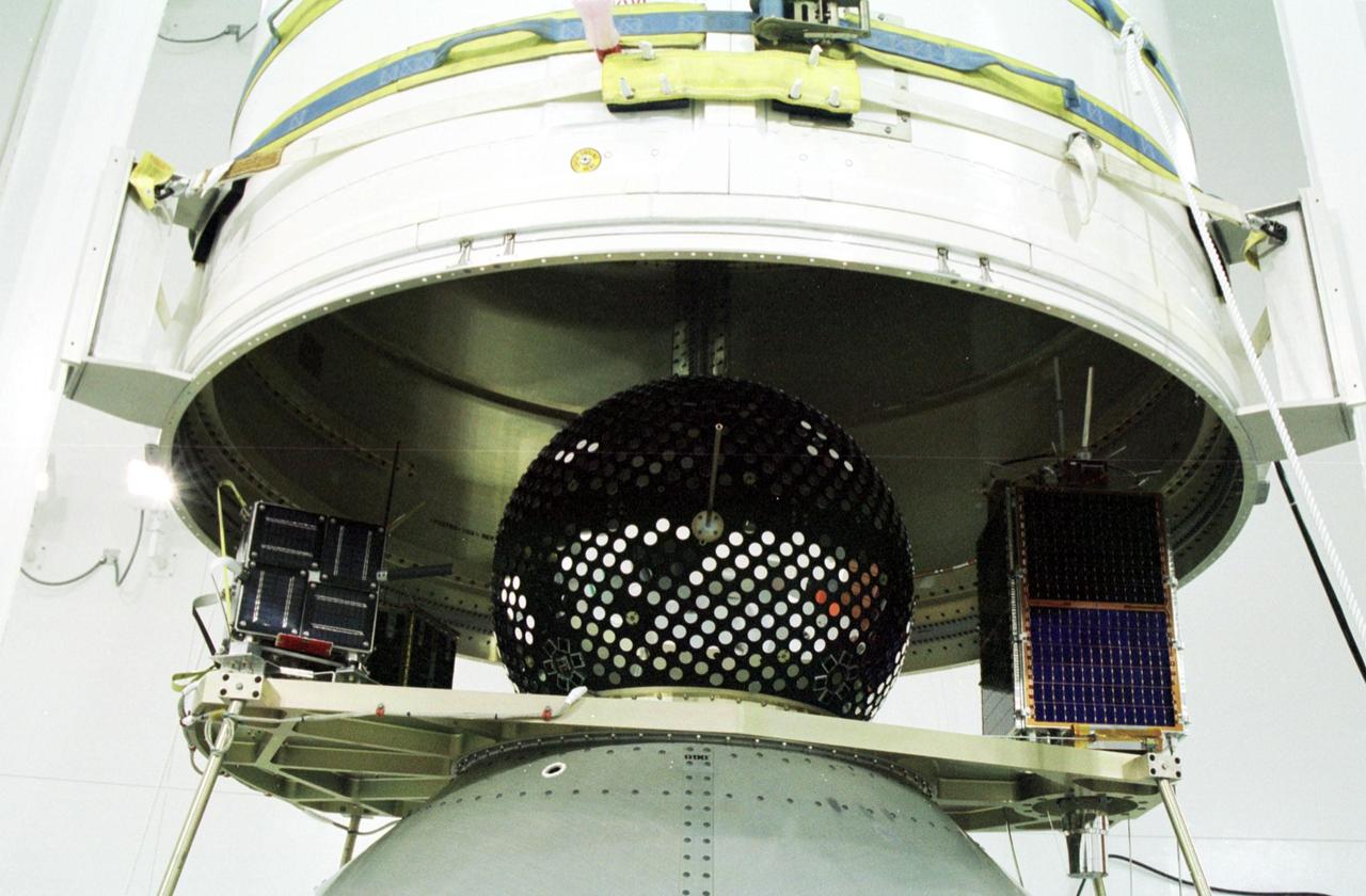 KODIAK ISLAND, Alaska -- At the Launch Service Structure, Kodiak Launch Complex (KLC), the fairing is lowered over the Kodiak Star spacecraft in preparation for launch. The first orbital launch to take place from KLC, Kodiak Star is scheduled to lift off on a Lockheed Martin Athena I launch vehicle on Sept. 17 during a two-hour window that extends from 5 p.m. ADT. The payloads aboard include the Starshine 3, sponsored by NASA, and the PICOSat, PCSat and Sapphire, sponsored by the Department of Defense (DoD) Space Test Program. KLC is the newest commercial launch complex in the United States, ideal for launch payloads requiring low-Earth polar or sun-synchronous orbits