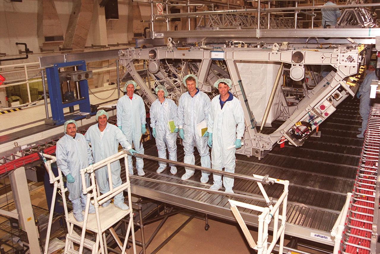 KENNEDY SPACE CENTER, Fla. --  Members of the STS-112 crew pose for a photo while looking over the Integrated Truss Structure (ITS) S1 (behind them).  The ITS S1 is part of the payload on the mission.  Standing left to right are Mission Specialists Fyodor Nikolayevich Yurchikhin, a cosmonaut with the Russian Aviation and Space Agency, David A. Wolf, and Sandra H. Magnus; Pilot Pamela A. Melroy; Mission Specialist Piers J. Sellers; and Commander Jeffrey S. Ashby. Mission STS-112 is scheduled for launch in July 2002