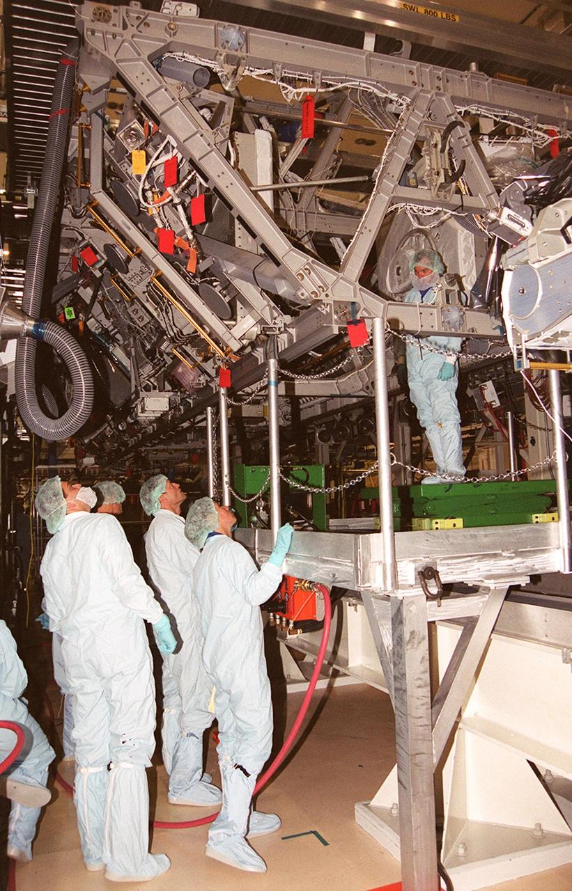 KENNEDY SPACE CENTER, Fla. - From the floor of the Operations and Checkout Bldg,, members of the STS-112 crew look over the Integrated Truss Structure (ITS) S1 above them that will be part of the payload on the mission. The crew comprises Commander Jeffrey S. Ashby, Pilot Pamela A. Melroy and Mission Specialists David A. Wolf, Piers J. Sellers, Sandra H. Magnus and Fyodor Nikolayevich Yurchikhin, a cosmonaut with the Russian Aviation and Space Agency.    Mission STS-112 is scheduled for launch in July 2002.