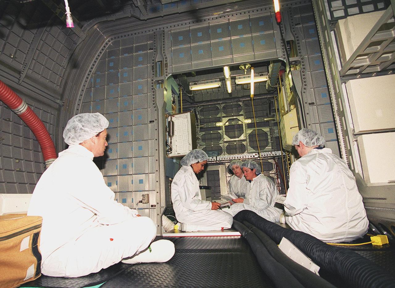KENNEDY SPACE CENTER, Fla. -- At SPACEHAB, Cape Canaveral, members of the STS-107 crew look over elements in the SPACEHAB Double Module as part of equipment familiarization for their mission. The crew comprises Commander Rick Husband, Pilot William McCool, Payload Commander Michael Anderson, Mission Specialists Kalpana Chawla, David Brown and Laurel Clark, and Payload Specialist Ilan Ramon. STS-107 has two payload elements, the Double Module in its first flight into space and a Hitchhiker payload. The double module provides greater experiment capability than on previous flights, resulting for this mission in a very broad collection of experiments for NASA and commercial and European customers. The experiments range from material sciences to life sciences (many rats). The Hitchhiker carrier system is modular and expandable in accordance with payload requirements, which allows maximum efficiency in utilizing orbiter resources and increases the potential for early manifesting on the Shuttle. Hitchhiker experiments are housed in canisters or attached to mounting plates. The Hitchhiker canister comes in two varieties--the Hitchhiker Motorized Door Canister and the Sealed Canisters. STS-107 is scheduled to launch in May 2002