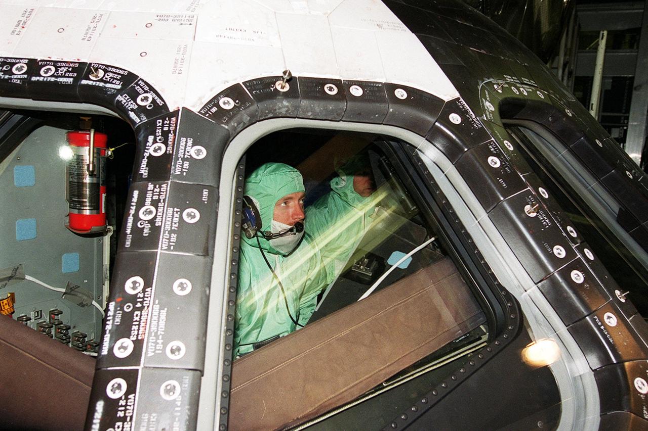 KENNEDY SPACE CENTER, Fla. -- During Crew Equipment Interface Test (CEIT) activities at KSC, STS-108 Pilot Mark E. Kelly checks the windshield inside orbiter Endeavour.  The CEIT provides familiarization with the launch vehicle and payload. Mission STS-108 is a Utilization Flight (UF-1), carrying the Expedition Four crew plus Multi-Purpose Logistics Module Raffaello to the International Space Station.   The mission crew comprises Commander Dominic L. Gorie, Kelly and Mission Specialists Linda A. Godwin and Daniel M. Tani.   The Expedition Four crew comprises Yuri Onufriyenko, commander, Russian Aviation and Space Agency, and astronauts Daniel W. Bursch and Carl E. Walz. Endeavour is scheduled to launch Nov. 29 on mission STS-108