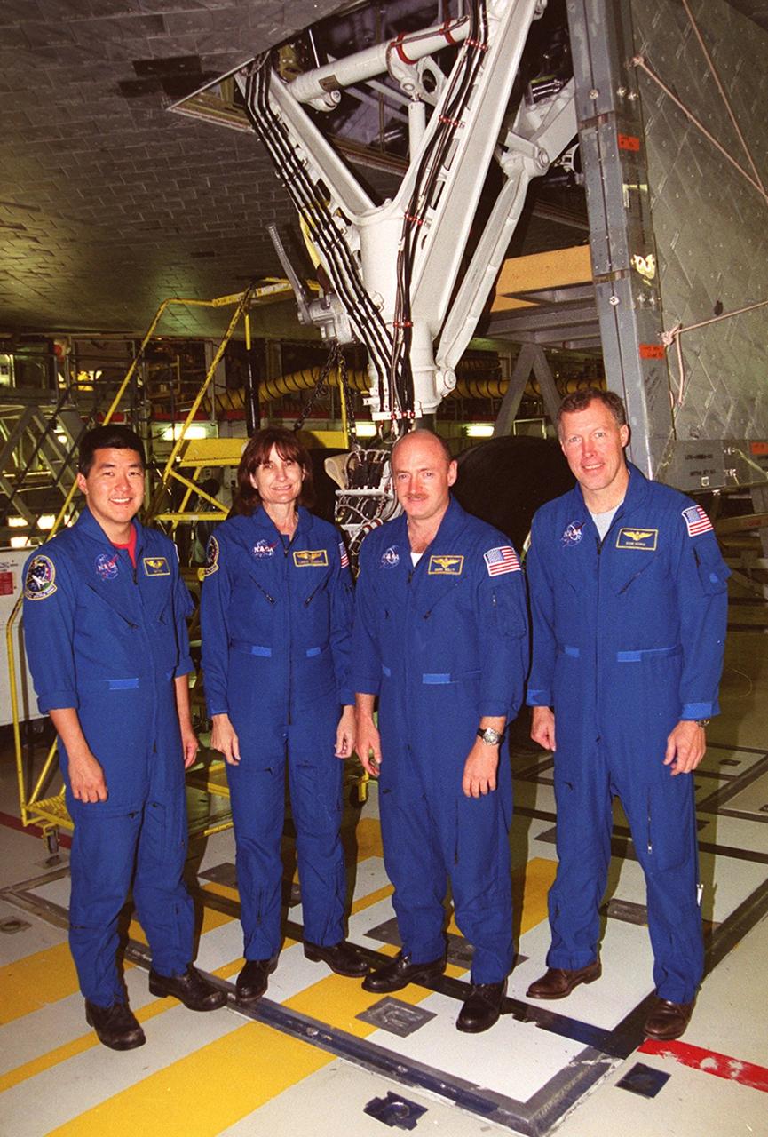 KENNEDY SPACE CENTER, Fla. --   The STS-108 crew pauses for a photo during Crew Equipment Interface Test activities at KSC.  From left are Mission Specialists Daniel M. Tani and Linda A. Godwin; Pilot Mark E. Kelly; and Commander Dominic L. Gorie. The CEIT provides familiarization with the launch vehicle and payload.  Mission STS-108 is a Utilization Flight (UF-1), carrying the Expedition Four crew plus Multi-Purpose Logistics Module Raffaello to the International Space Station.  The Expedition Four crew comprises Yuri Onufriyenko, commander, Russian Aviation and Space Agency, and astronauts Daniel W. Bursch and Carl E. Walz. Endeavour is scheduled to launch Nov. 29 on mission STS-108