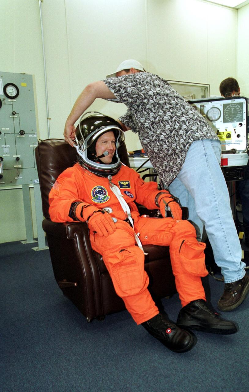 KENNEDY SPACE CENTER, Fla. --   STS-108 Commander Dominic L. Gorie gets help with his helmet during suit and pre-pack fit check.  Gorie and other crew members are preparing to take part in a simulated launch countdown, part of Terminal Countdown Demonstration Test activities.  The TCDT also includes emergency exit training from the orbiter and launch pad. STS-108 is a Utilization Flight that will carry the replacement Expedition 4 crew to the International Space Station, as well as the Multi-Purpose Logistics Module Raffaello, filled with supplies and equipment.  The l1-day mission is scheduled for launch Nov. 29 on Space Shuttle Endeavour