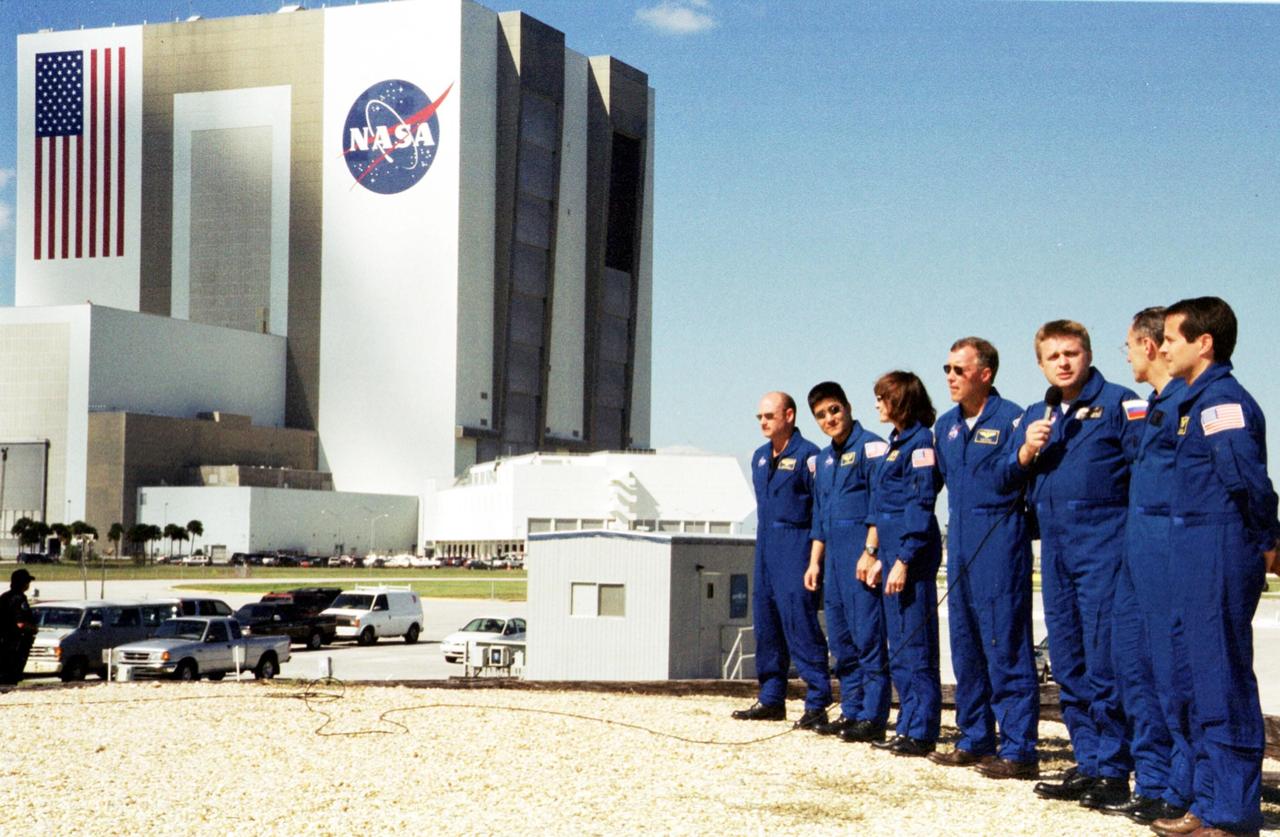 KENNEDY SPACE CENTER, Fla. -- The STS-108 crew and Expedition 4 crew answer questions from the media during an interview session.   With the microphone is Expedition 4 Commander Yuri Onufrienko. From left are STS-108 Pilot Mark E. Kelly, Mission Specialists Daniel M. Tani and Linda A. Godwin, and Commander Dominic L. Gorie; Onufrienko and Expedition 4 members Carl E. Walz and Daniel W. Bursch.  The crews are at KSC for Terminal Countdown Demonstration Test activities that include emergency exit training from the orbiter and launch pad and a simulated launch countdown.  STS-108 is a Utilization Flight that will carry the replacement Expedition 4 crew to the International Space Station, as well as the Multi-Purpose Logistics Module Raffaello, filled with supplies and equipment.  The l1-day mission is scheduled for launch Nov. 29 on Space Shuttle Endeavour