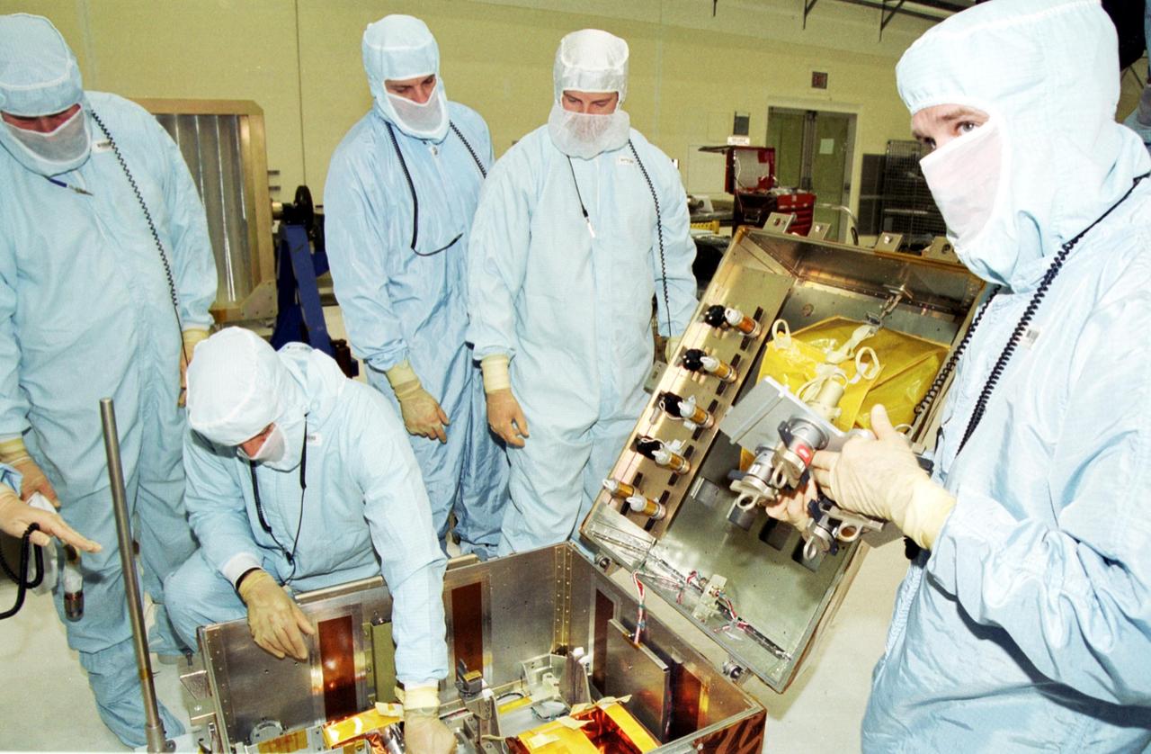 KENNEDY SPACE CENTER, Fla. --   Inside the Vertical Processing Facility, the STS-109 crew looks over equipment for their Hubble Space Telescope (HST) Servicing mission.  Seen are (starting second from left), Mission Specialists Michael Massimino and Richard Linnehan, Commander Scott Altman and Payload Commander John Grunsfeld.  Other crew members are Pilot Duane Carey and Mission Spcialists Nancy Currie and James Newman.   The goal of the mission is to service the HST, replacing Solar Array 2 with Solar Array 3, replacing the Power Control Unit, removing the Faint Object Camera and installing the Advanced Camera for Surveys, installing the Near Infrared Camera and Multi-Object Spectrometer (NICMOS) Cooling System, and installing New Outer Blanket Layer insulation on bays 5 through 8.  Mission STS-109 is scheduled for launch Feb. 14, 2002